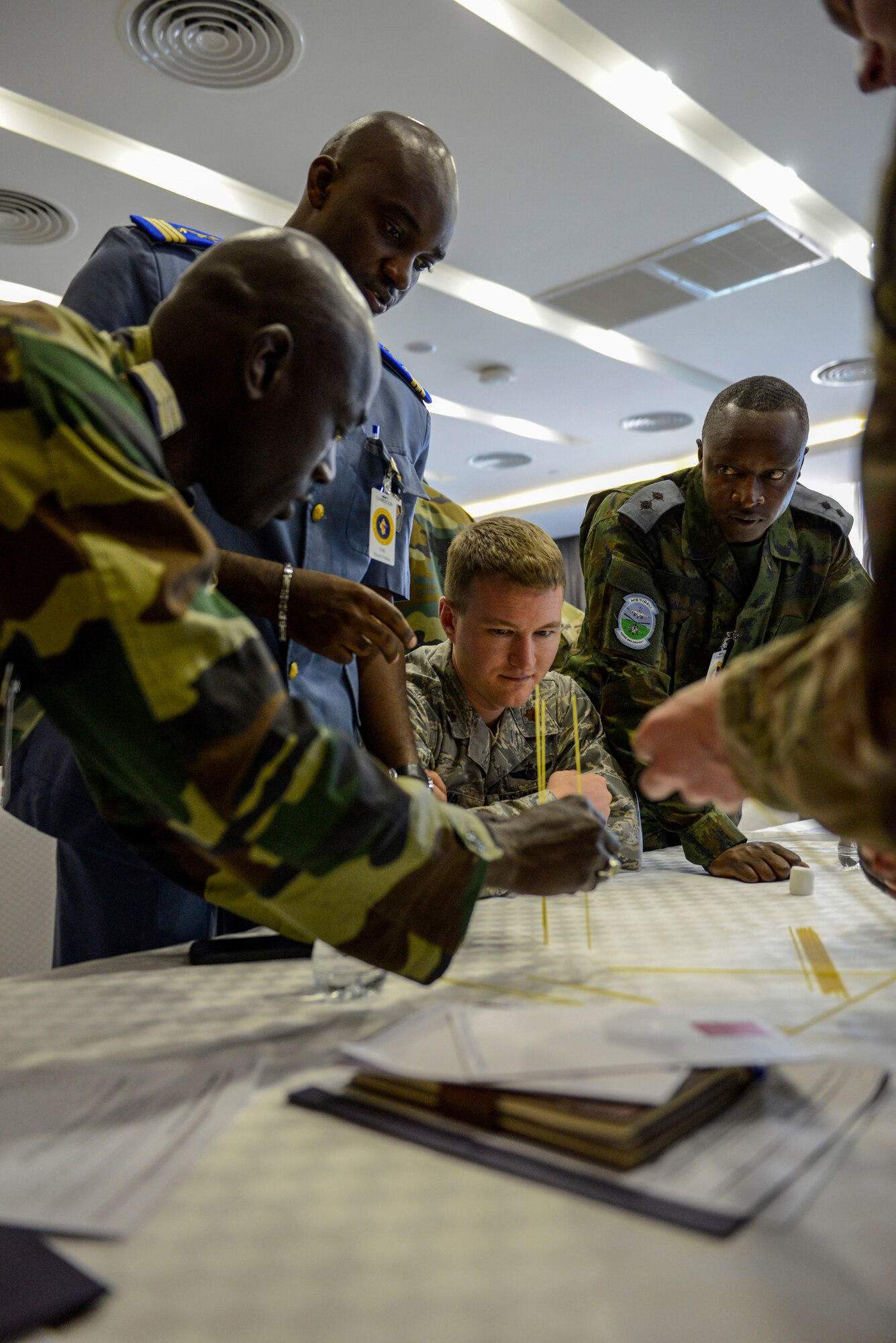 Participants in the African Partnership Flight Rwanda work together during an ice breaker - the marshmallow challenge - in Kigali, Rwanda, March 4, 2019. The challenge is designed to facilitate communication within teams and get them to look at a task from various perspectives. The African Partnership Flight program aims to build aviation capacity, enhance regional cooperation, and increase interoperability by creating opportunities for African nations to work and collaborate together. (U.S. Air Force photo by Tech. Sgt. Timothy Moore)