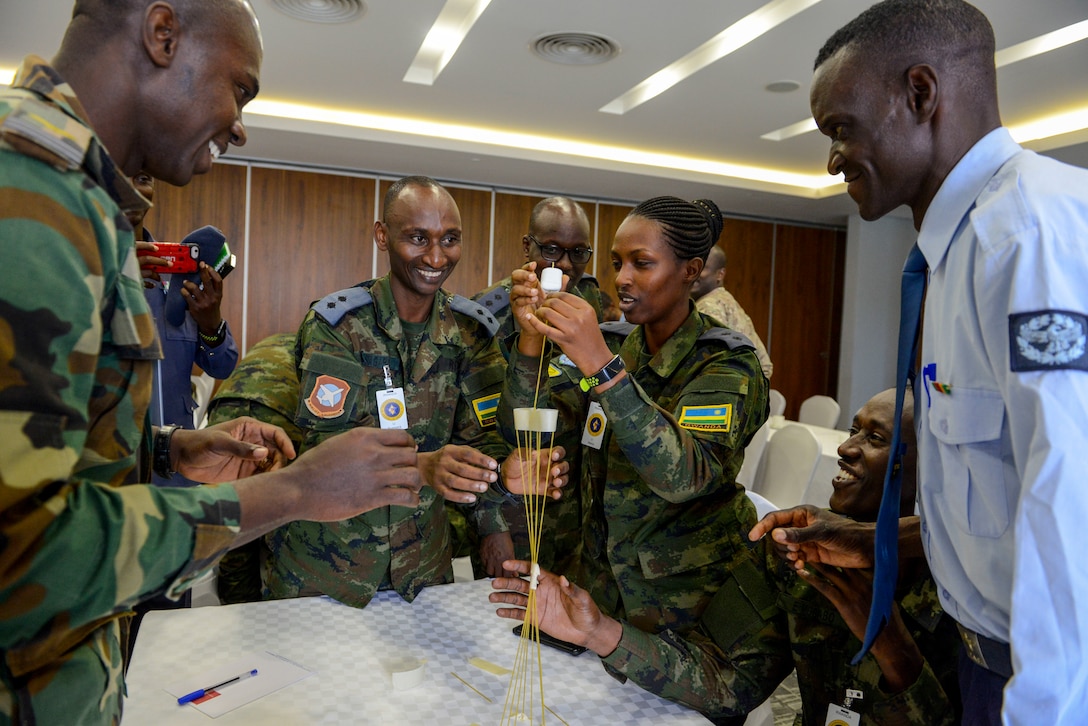 Participants in the African Partnership Flight Rwanda work together during an ice breaker - the marshmallow challenge - in Kigali, Rwanda, March 4, 2019. The challenge is designed to facilitate communication within teams and get them to look at a task from various perspectives. The African Partnership Flight program aims to build aviation capacity, enhance regional cooperation, and increase interoperability by creating opportunities for African nations to work and collaborate together. (U.S. Air Force photo by Tech. Sgt. Timothy Moore)