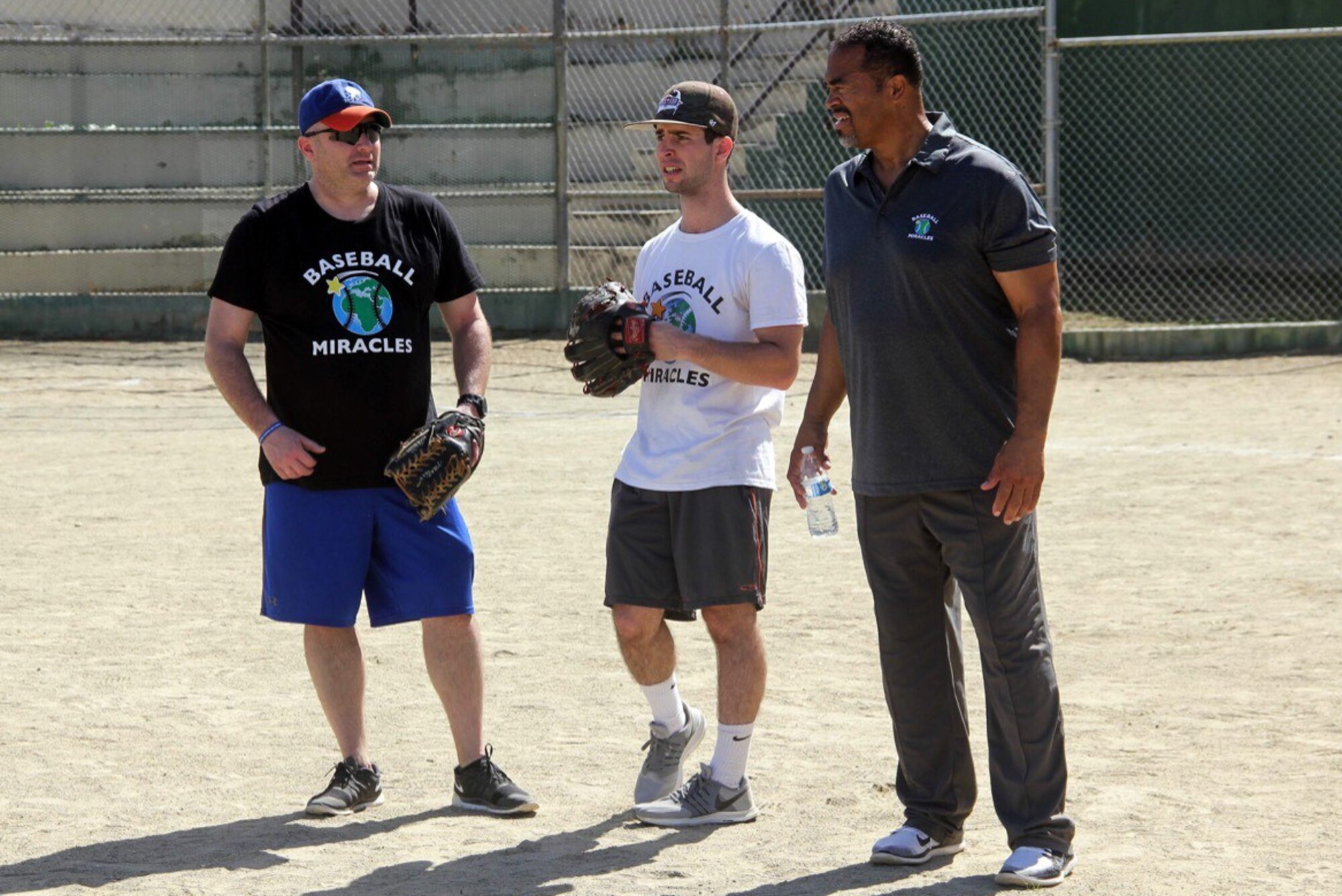 Air Force Chief Master Sgt. Greg Souders, left, the superintendent of the 193rd Special Operations Logistics Readiness Squadron, Pennsylvania Air National Guard, speaks with fellow Baseball Miracles members Kyle Bamberger and Daraka Shaheed during a Baseball Miracles event.