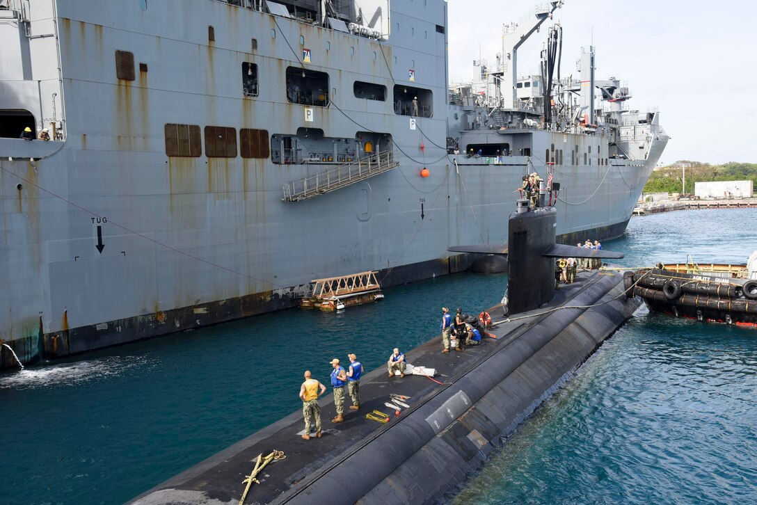 APRA HARBOR, Guam (March 11, 2019) – USS Oklahoma City (SSN 723), a Los Angeles-class submarine, prepares to moor next to USNS Cesar Chavez (T-AKE 14) during an exercise in Apra Harbor, March 11. The exercise aims to assess the capabilities of USNS vessels to service submarines while in port and underway.