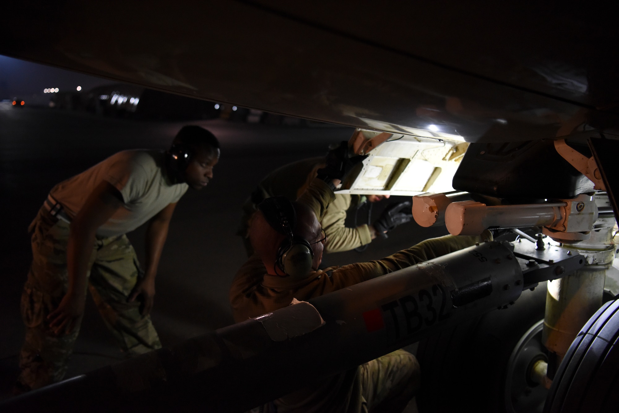 380th Expeditionary Aircraft Maintenance Squadron crew chief members inspect the wheel of an E-3 Sentry after landing at Al Dhafra Air Base, United Arab Emirates, Mar. 7, 2019.