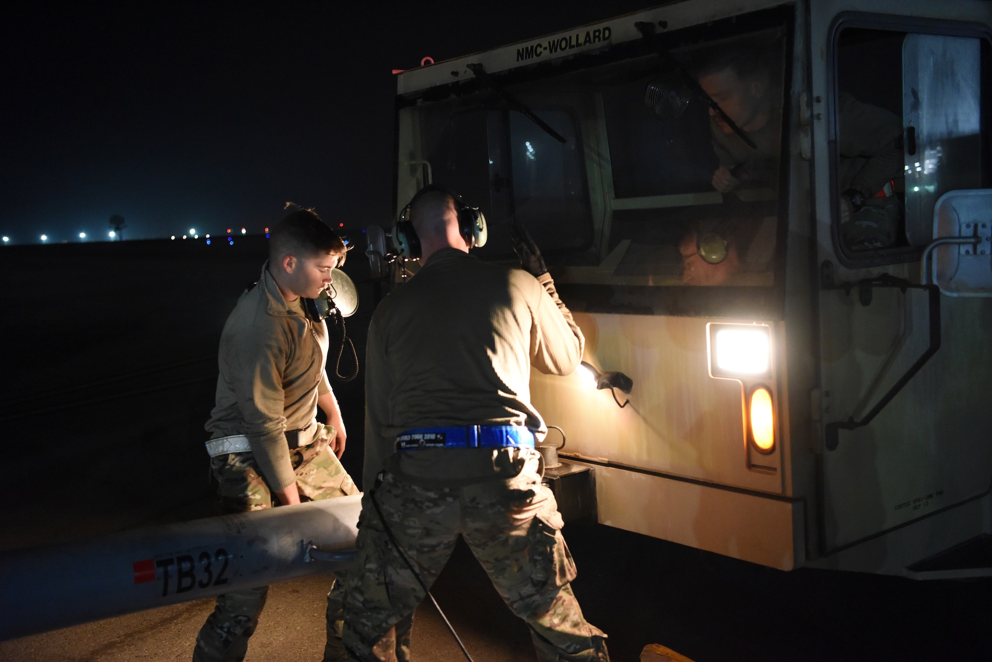 380th Expeditionary Aircraft Maintenance Squadron crew chief members attach the tow to an E-3 Sentry to taxi into Al Dhafra Air Base, United Arab Emirates, Mar. 7, 2019.