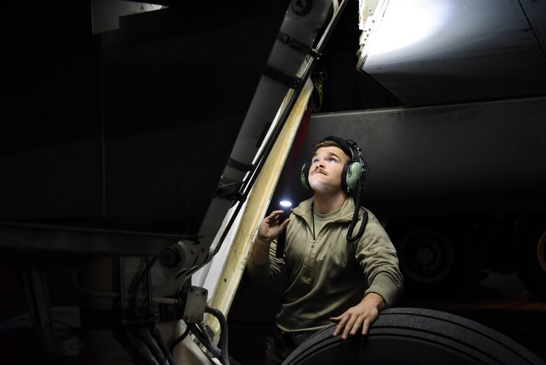 Senior Airman Devon Gilbert, 380th Expeditionary Aircraft Maintenance Squadron crew chief, inspects an E-3 Sentry after landing at Al Dhafra Air Base, United Arab Emirates, Mar. 7, 2019.