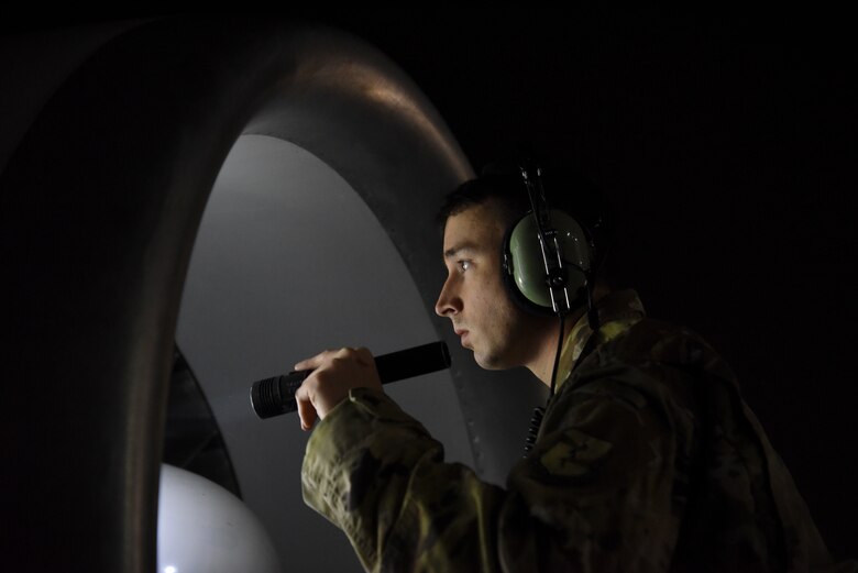An 380th Expeditionary Aircraft Maintenance Squadron crew chief inspects the engine of an E-3 Sentry at Al Dhafra Air Base, United Arab Emirates, Mar. 7, 2019.