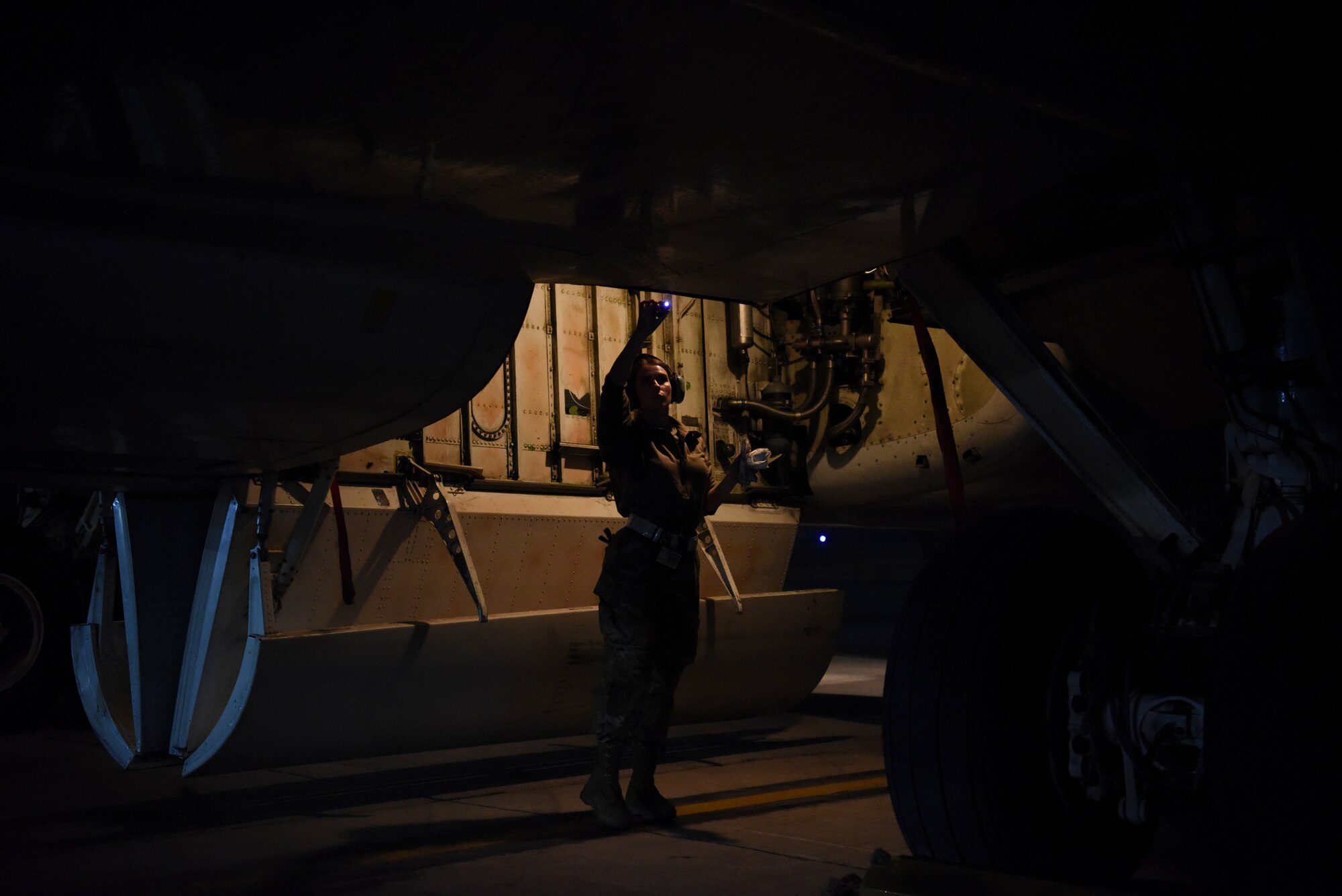 Senior Airman Larissa Locke, 380th Expeditionary Aircraft Maintenance Squadron hydraulics systems specialist, inspects the compartments of an E-3 Sentry after landing at Al Dhafra Air Base, United Arab Emirates, Mar. 7, 2019.