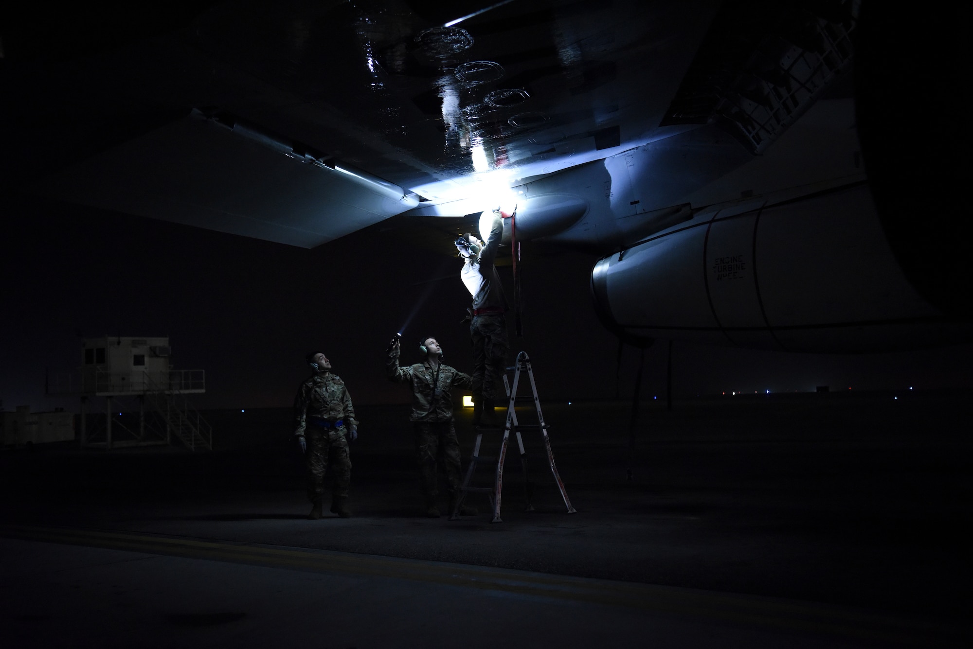 380th Expeditionary Aircraft Maintenance Squadron crew chief members inspect underneath the wing of an E-3 Sentry after landing at Al Dhafra Air Base, United Arab Emirates, Mar. 7, 2019.