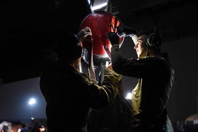 380th Expeditionary Aircraft Maintenance Squadron crew chief members inspect an E-3 Sentry after landing at Al Dhafra Air Base, United Arab Emirates, Mar. 7, 2019.