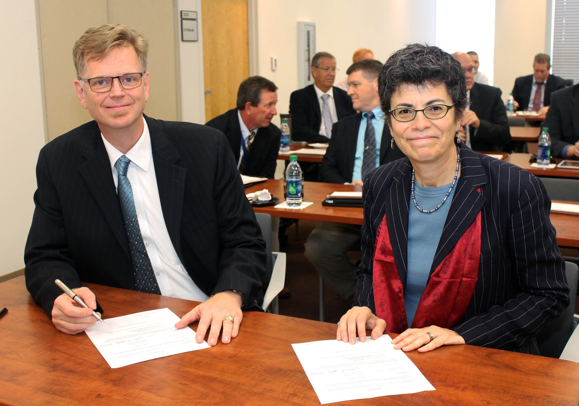 Dr. Glenn E. Sjoden (left) and Dr. Gisele Bennett (right) prepare to renew the Cooperative Research and Development Agreement between the Air Force Technical Applications Center and the Florida Institute of Technology March 1, 2019 on the FIT campus in Melbourne, Florida.  Sjoden, AFTAC's chief scientist, and Bennett, FIT's senior vice president for research, signed the CRADA to allow for scientific collaboration between the two organizations.  (Florida Institute of Technology photo by Adam Lowenstein)