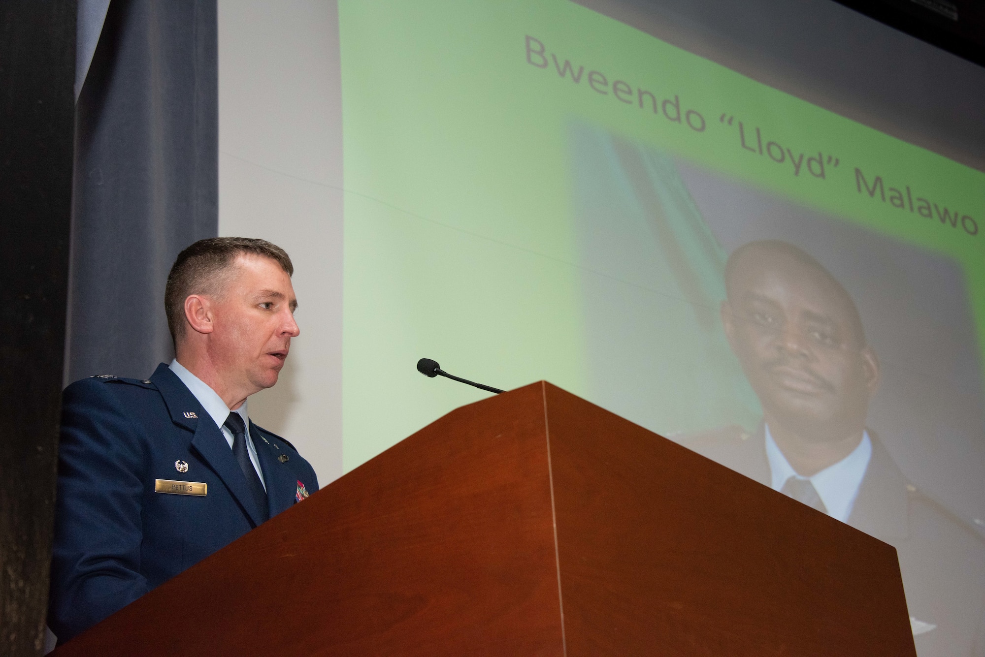 U.S. Air Force Col. Evan Pettus, commandant of Air Command and Staff College, speaks about the impact Zambian air force Maj. Bweendo “Lloyd” Malawo had on his flight and the faculty and students of ACSC, during a memorial service March 8. Malawo was killed March 2 in a hit and run in Millbrook, Alabama, and left behind a wife and two children. (U.S. Air Force photo by Melanie Rodgers Cox)