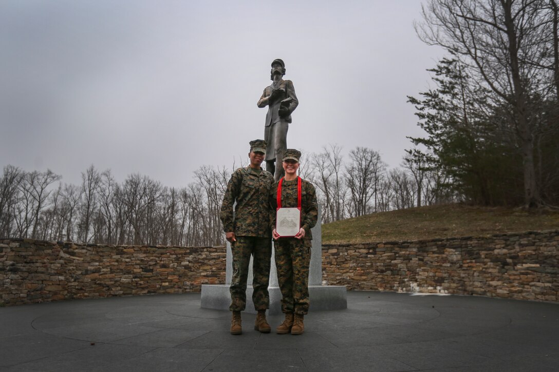 U.S. Marine Corps Sgt. Maj. Robin Fortner and Cpl. Haley Mathers pose for a photo at the National Museum of the Marine Corps in Triangle, Virginia on March 8, 2019. As a tribute to 101 years of women serving in the Marine Corps, the ceremony was held in front of a replica of the Molly Marine statue, the first monument of a female in a service uniform and tribute to the first female Marines. Sgt. Maj. Robin Fortner, the Marine Corps Systems Command sergeant major, said that Marines such as Mathers are recognized for taking enormous pride in their work and producing quality results. (U.S. Marine Corps photo by Lance Cpl. Phuchung Nguyen)