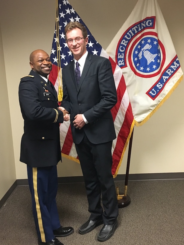 Newly commissioned Lt. Col. Stephen Bayles, M.D., F.A.C.S, is congratulated by Maj. Richard Smith, Seattle Medical Recruiting Station officer-in-charge