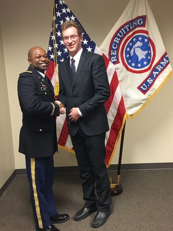 Newly commissioned Lt. Col. Stephen Bayles, M.D., F.A.C.S, is congratulated by Maj. Richard Smith, Seattle Medical Recruiting Station officer-in-charge