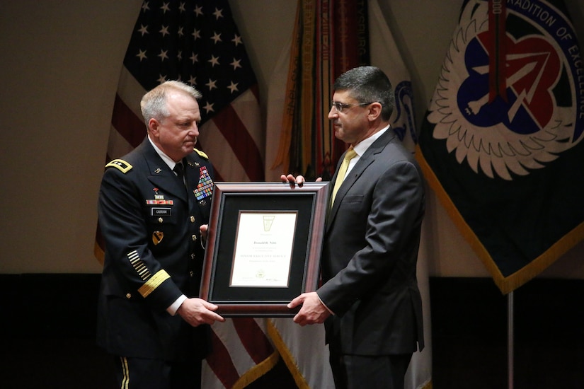 Logistics Center Executive Director, Don Nitti, his certificate of appointment into the Senior Executive Service