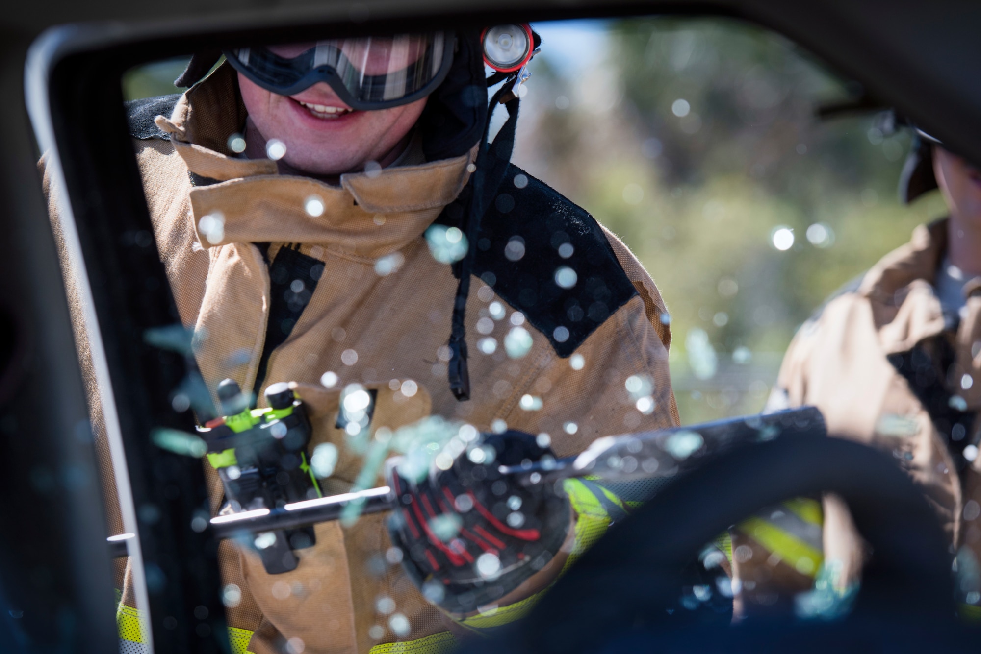 A 6th Civil Engineer Squadron firefighter breaks a car window during a joint firefighting training exercise at MacDill Air Force Base, Fla., March 6, 2019.