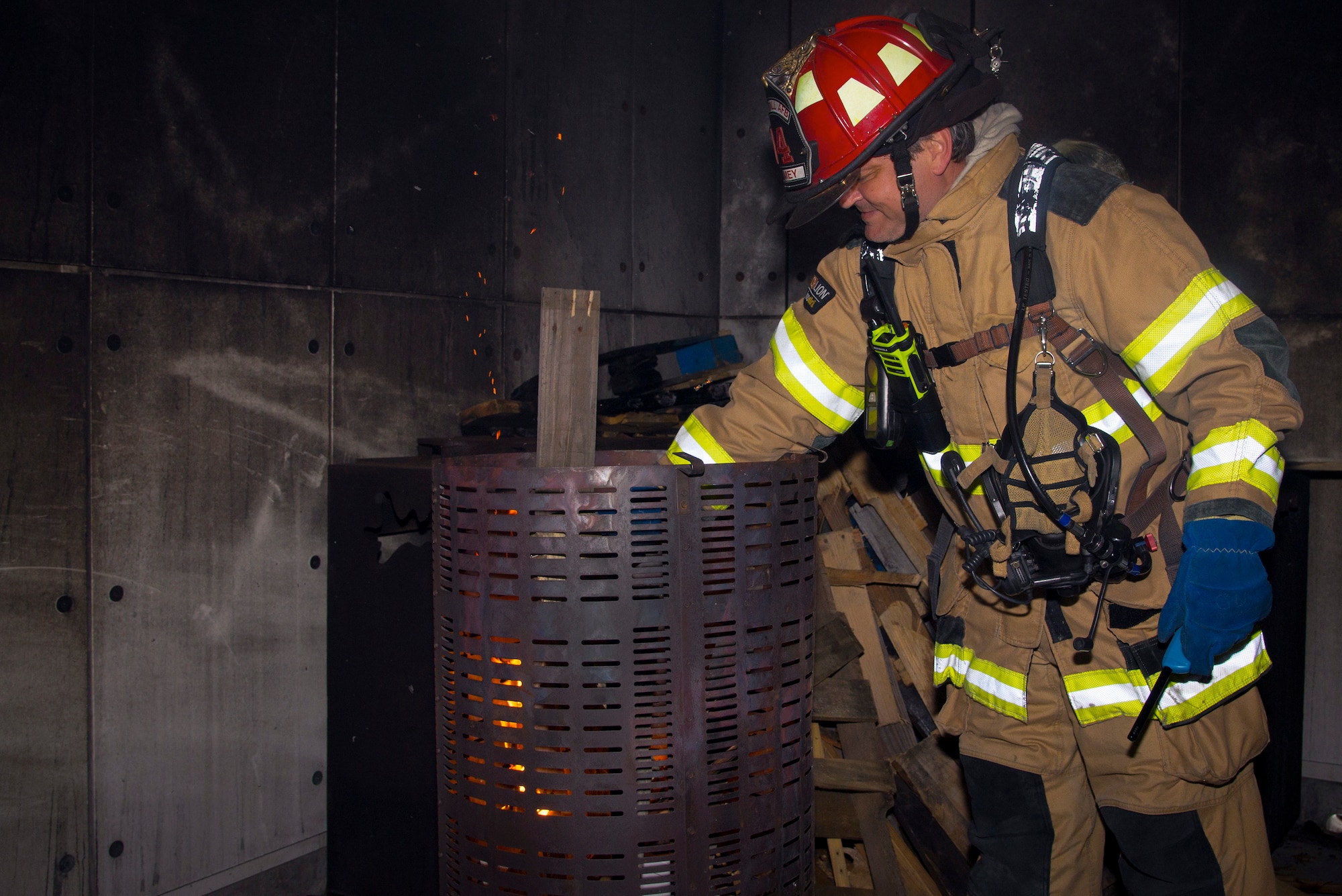 A 6th Civil Engineer Squadron firefighter starts a fire in a live-fire structural training facility during a joint firefighting training exercise with Airmen from the 153rd Airlift Wing at MacDill Air Force Base, Fla., March 5, 2019.