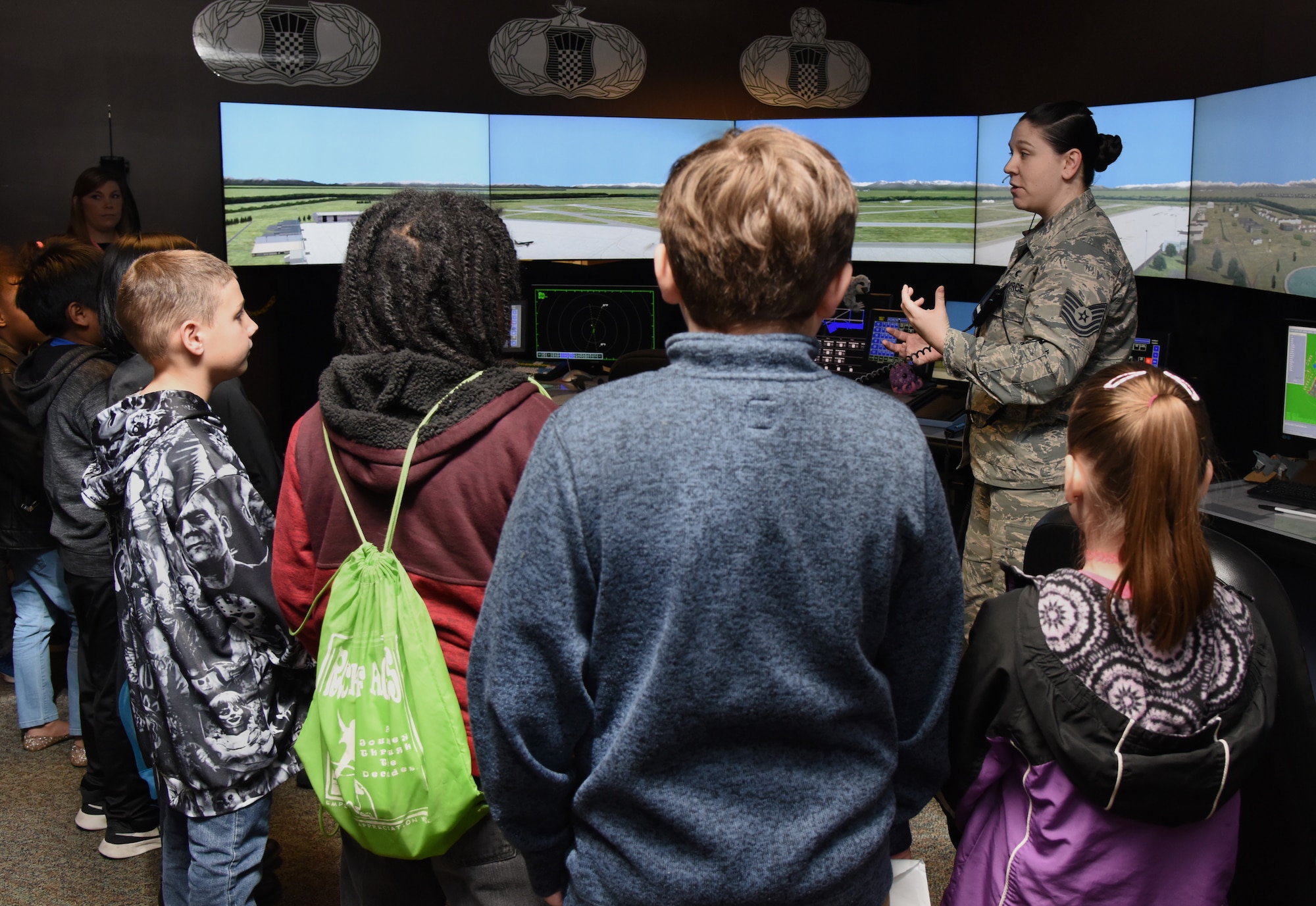 U.S. Air Force Tech. Sgt. Carolyn Alexander, 334th Training Squadron instructor, provides an air traffic control tower simulator demonstration to school-aged children during Biloxi School District Career Exploration Day on Keesler Air Force Base, Mississippi, March 7, 2019. The children also toured the Keesler Fire Department, 335th TRS weather facility and received a demonstration from the 81st Security Forces Squadron military working dogs. (U.S. Air Force photo by Kemberly Groue)