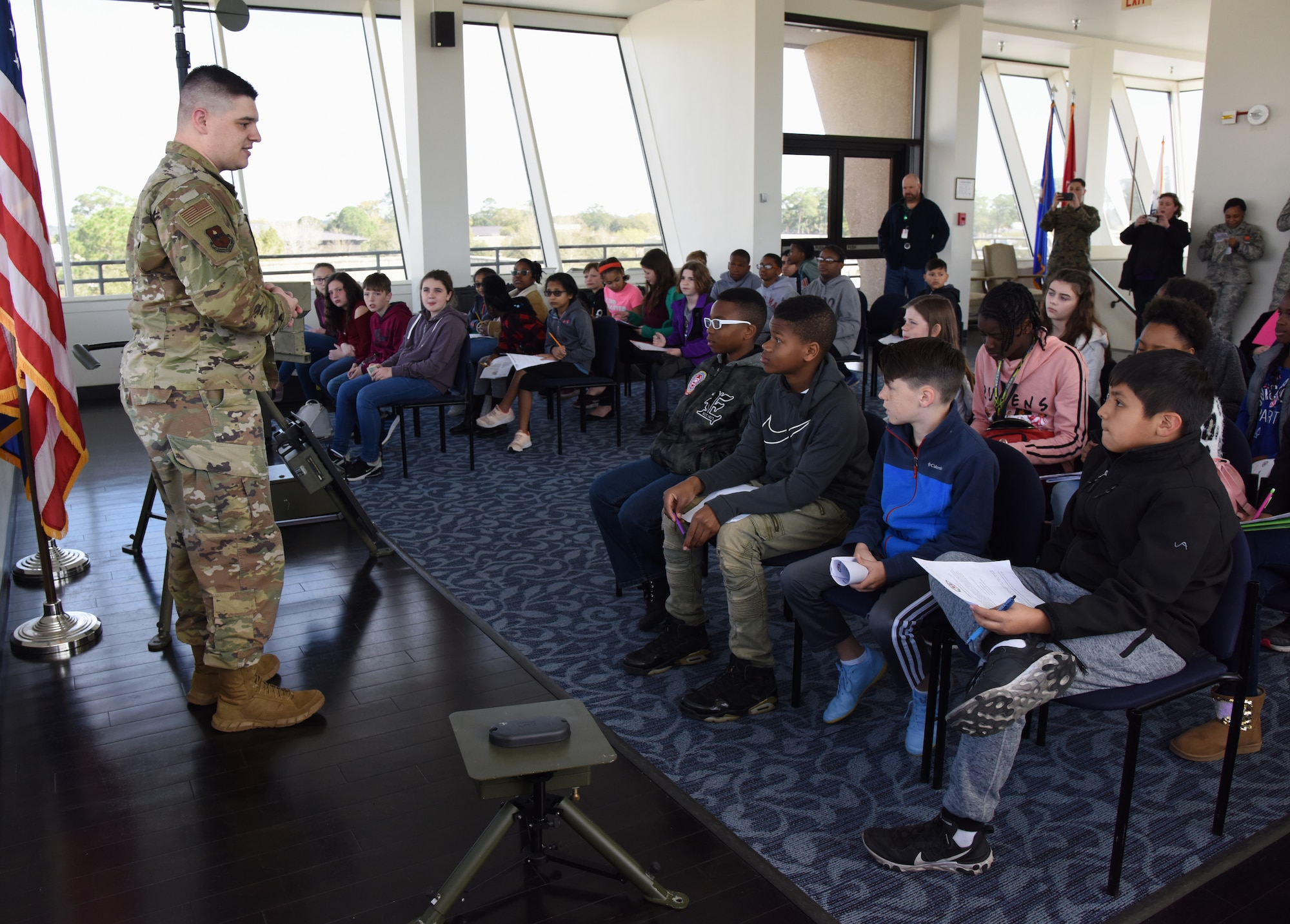 U.S. Air Force Staff Sgt. Christopher Spears, 335th Training Squadron instructor, provides a weather training briefing to school-aged children during Biloxi School District Career Exploration Day on Keesler Air Force Base, Mississippi, March 7, 2019. The children also toured the Keesler Fire Department, 334th TRS air traffic control school and received a demonstration from the 81st Security Forces Squadron military working dogs. (U.S. Air Force photo by Kemberly Groue)