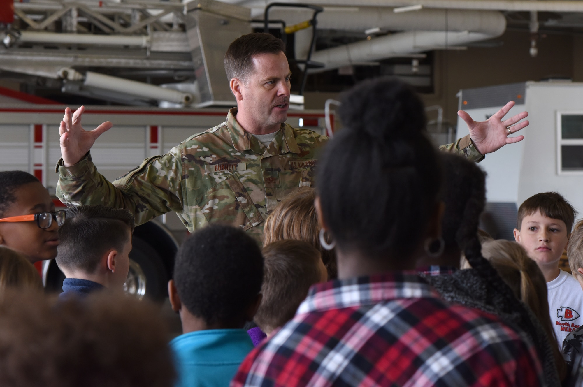 U.S. Air Force Col. Lance Burnett, 81st Training Wing vice commander, delivers closing remarks to school-aged children during Biloxi School District Career Exploration Day on Keesler Air Force Base, Mississippi, March 7, 2019. Throughout their visit, the children toured the 334th Training Squadron air traffic control school, 335th TRS weather facility, the Keesler Fire Department and received a demonstration from the 81st Security Forces Squadron military working dogs. (U.S. Air Force photo by Kemberly Groue)