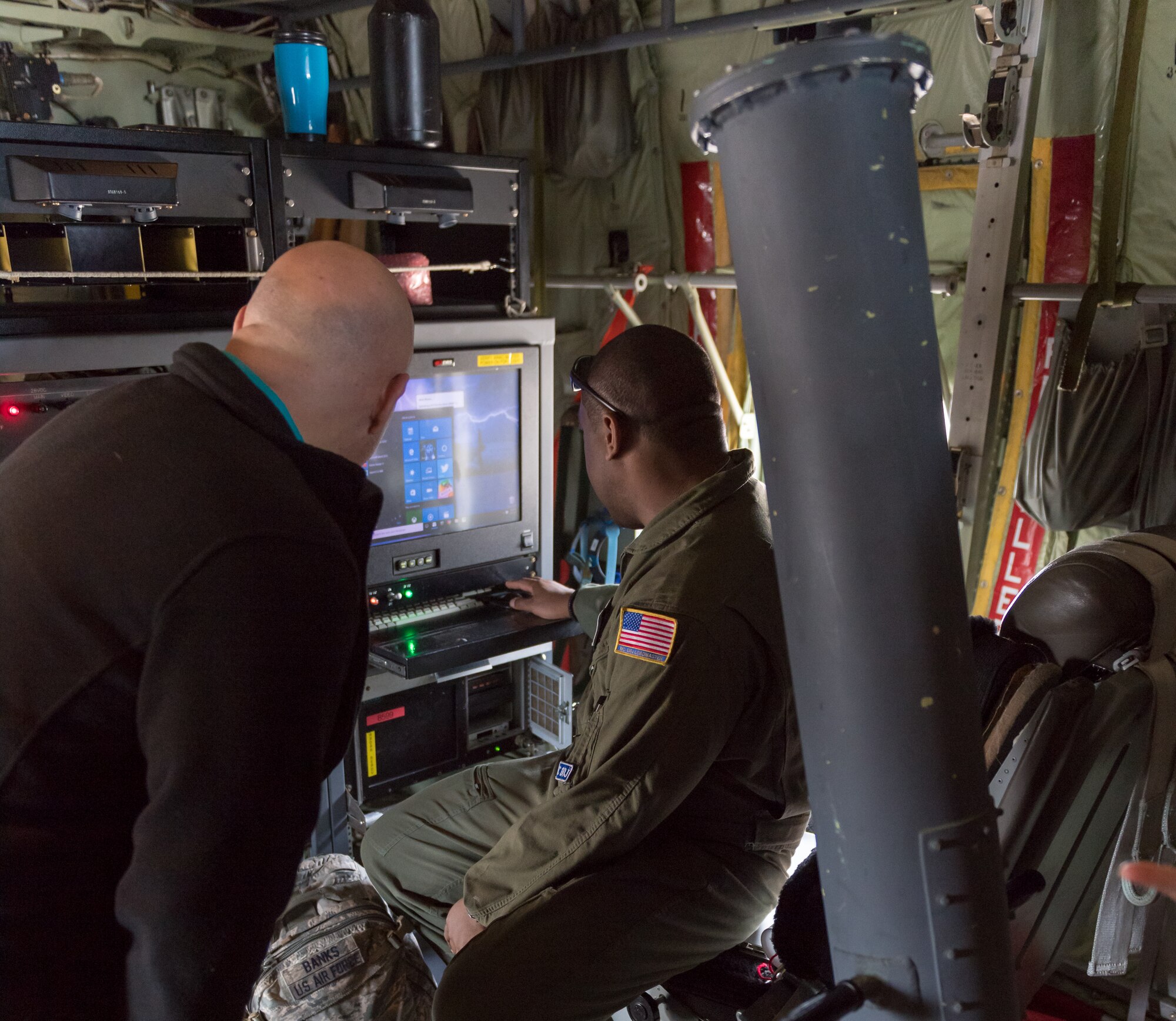 U.S. Air Force Tech. Sgt. Larry Banks, 53rd Weather Reconnaissance Squadron load master, shows the dropsonde data collection process inside a WC-130J Hercules to Michael Pocchiari, Garden Park Medical Center human resources vice president, during the 403rd Wing Honorary Commanders Tour at Keesler Air Force Base, Mississippi, March 08, 2019. The tour was intended to familiarize honorary commanders with the 403rd Wing and the Air Force Reserve mission and capabilities. The event also included an incentive flight on a WC-130J Hercules. (U.S. Air Force Photo by Andre' Askew)