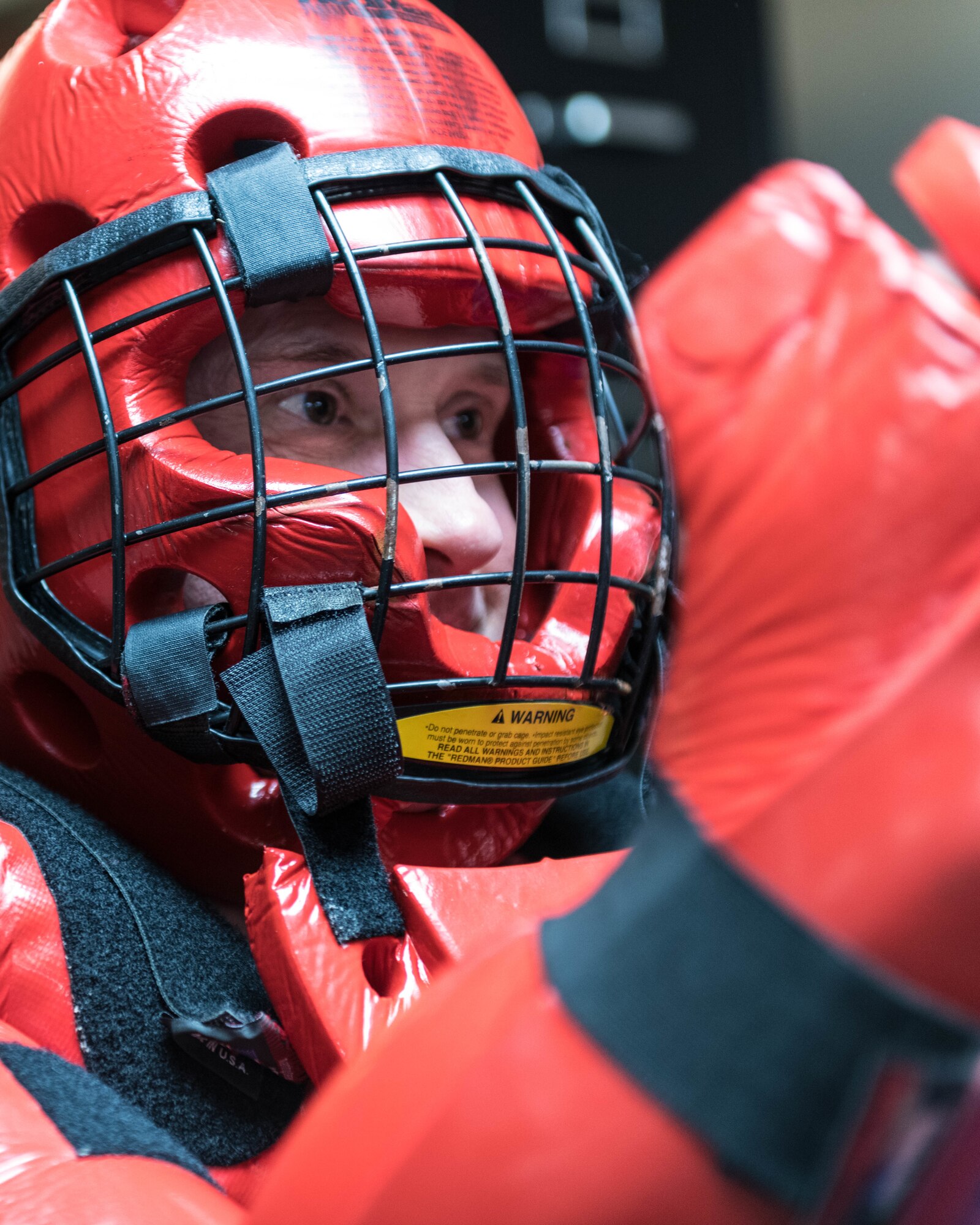 Master Sgt. Michael Skraba, training program manager for the 910th Security Forces Squadron, dons the “Red-Man” suit in preparation for a telescoping baton use of force examination.