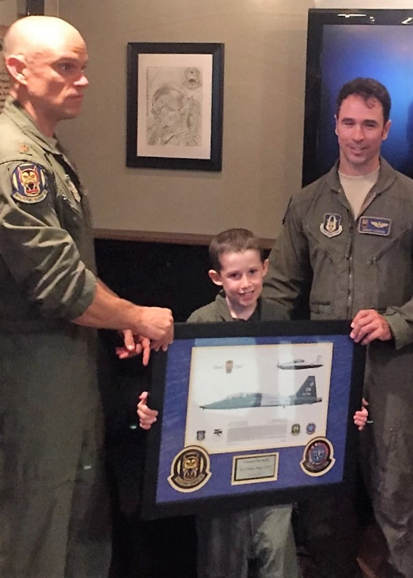 Maj. Elliott Nelsen (left) and Lt. Col. Jeremy Downs, 97th Flying Training Squadron, Sheppard Air Force Base, Texas, pose with Connor, a young cancer patient who had the one-in-a-lifetime opportunity to be an aircraft commander for a day thanks to Downs and Nelsen. When they learned about Connor’s illness and his desire to be a pilot, the 97th FTS instructor pilots worked with teammates across the 80th Flying Training Wing to make sure Connor had a day he would never forget. (Courtesy photo)