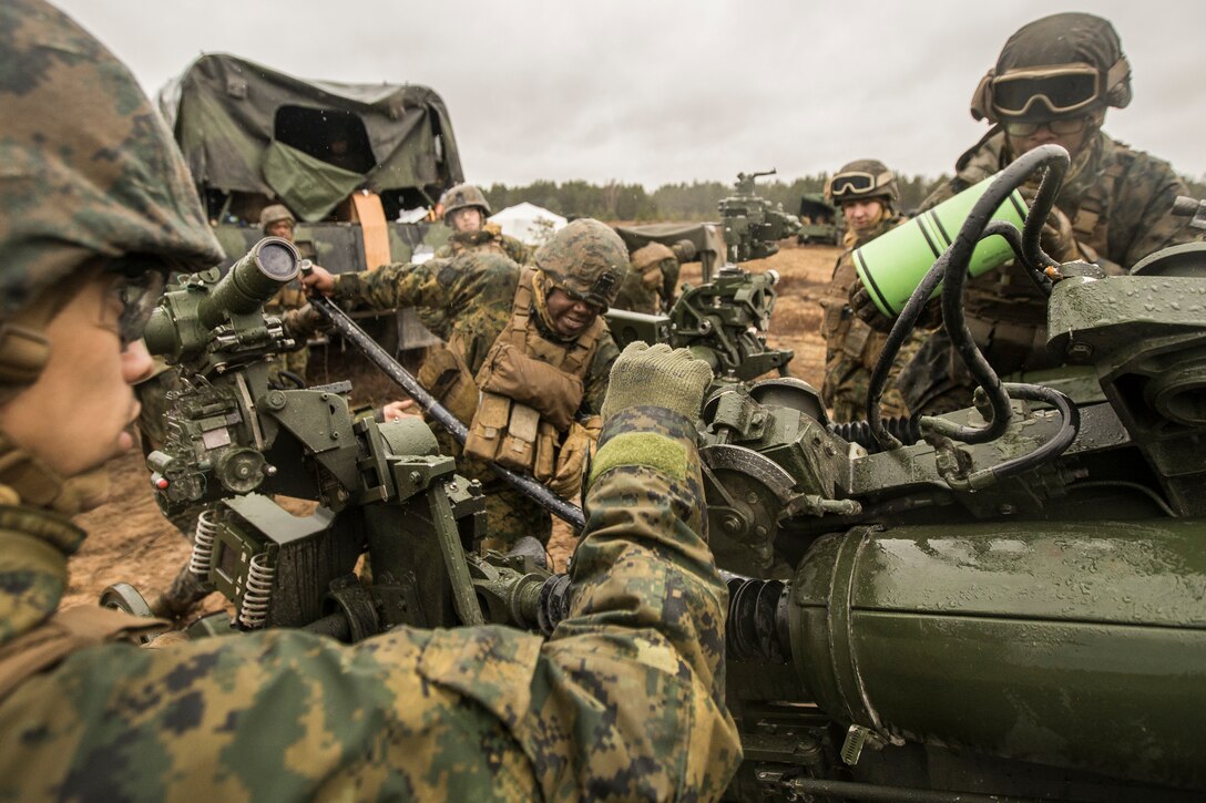 U.S. Marines with Hotel Battery, 3rd Battalion, 14th Marine Regiment, 4th Marine Division, load a M777 howitzer during a live-fire range at Adazi Training Area, Latvia, March 5, 2019, during exercise Dynamic Front 19.