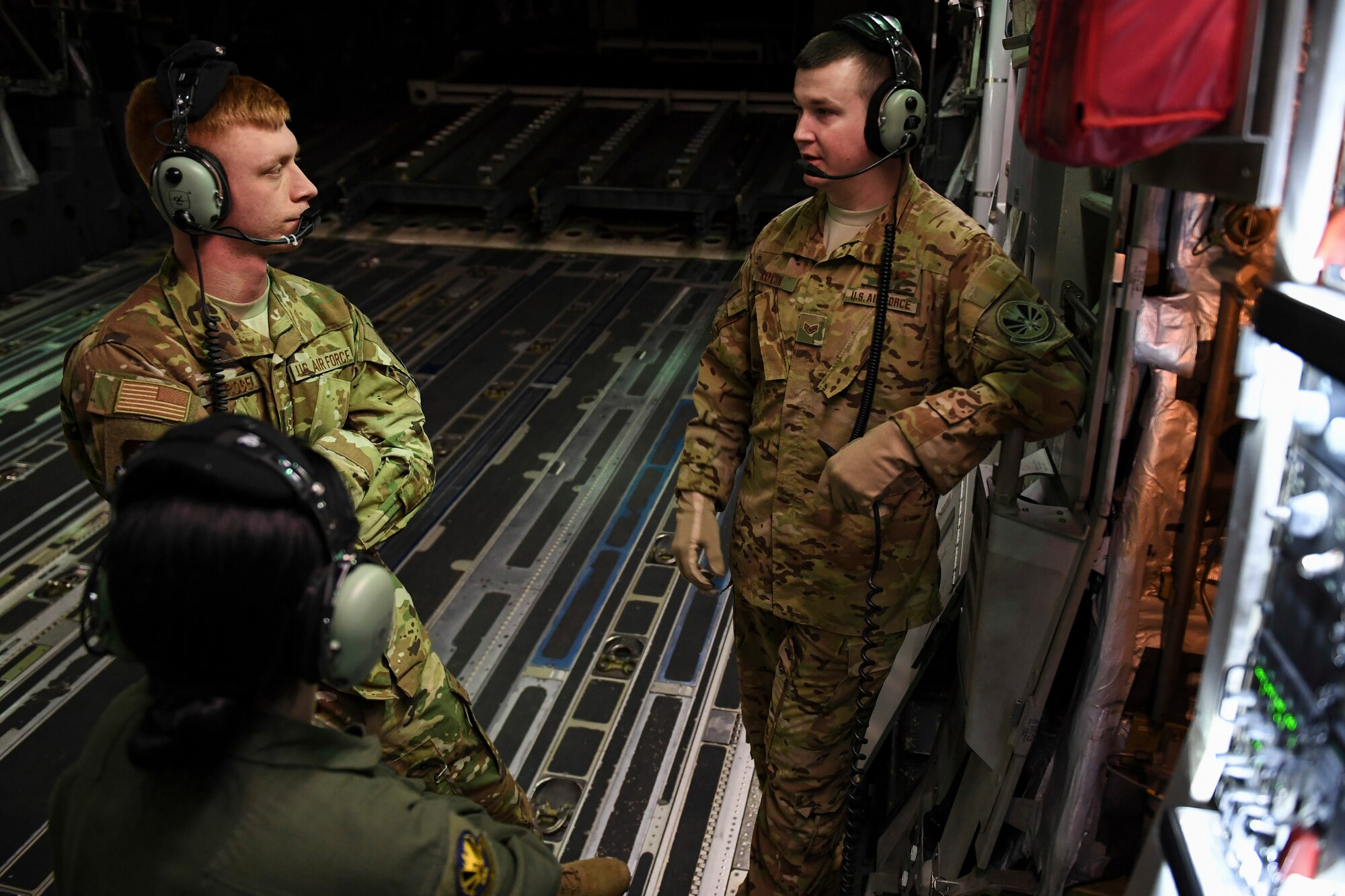 Senior Master Sgt. Becky Schatzman, Senior Airman Steven Strobel and Staff Sgt. Carl Kocon, loadmasters with the 758th Airlift Squadron discuss emergency in-flight procedures with, during a training flight to March Air Reserve Base, California, March 3, 2019. In order for loadmasters to be fully operational, they must complete approximately 50 tasks including night operation training, cargo loading operations, combat procedures, and in-flight emergency procedures. (U.S. Air Force photo by Joshua J. Seybert)