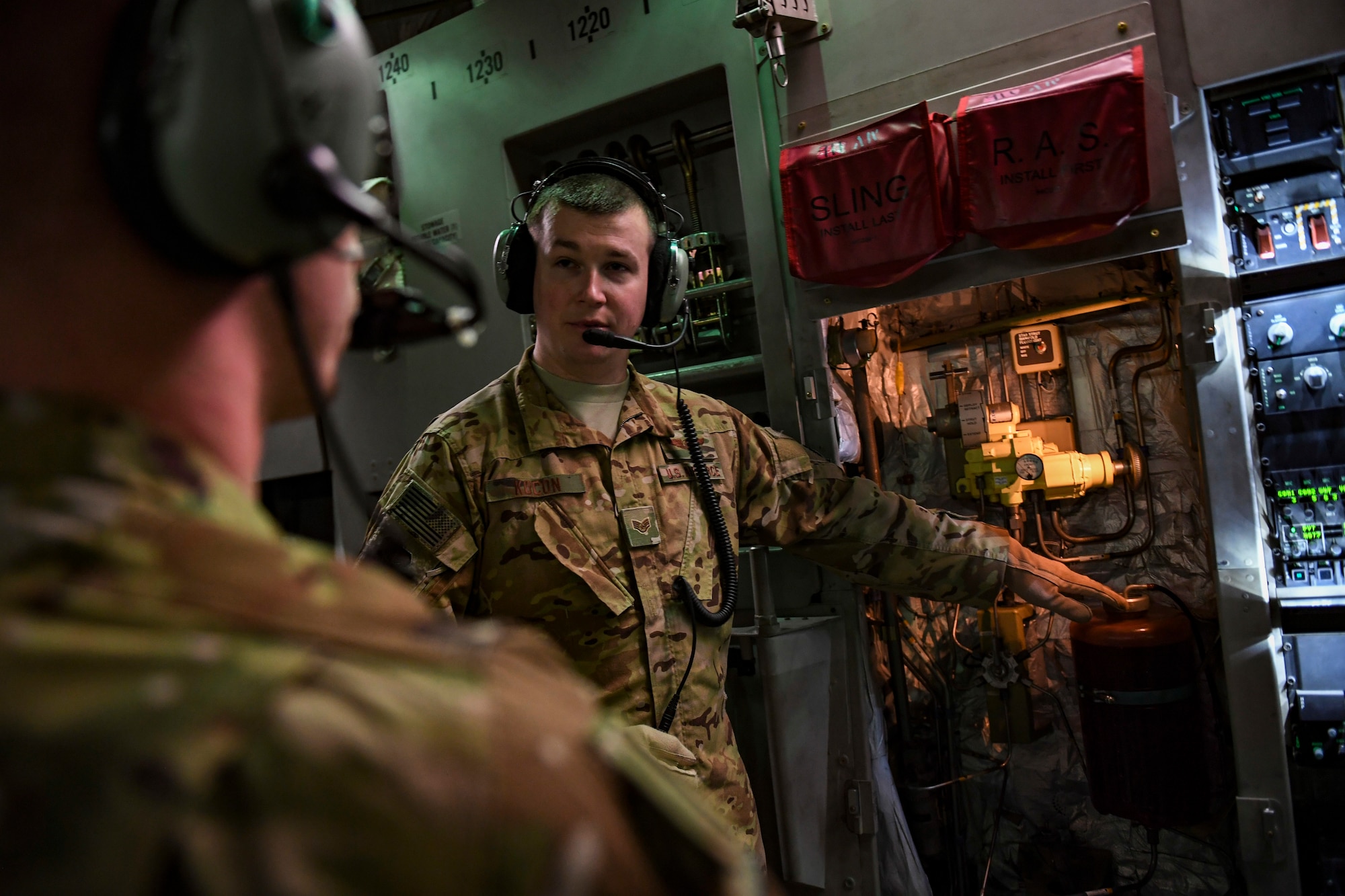 Staff Sgt. Carl Kocon, loadmaster with the 758th Airlift Squadron explains different parts of the hydraulic system to Senior Airman Steven Strobel, loadmaster with the 758th AS, during a training flight to March Air Reserve Base, California, March 3, 2019. Loadmasters might have to use the hydraulic system to add hydraulic fluid into the lines manually during an in-flight emergency, making this a vital training requirement. (U.S. Air Force photo by Joshua J. Seybert)