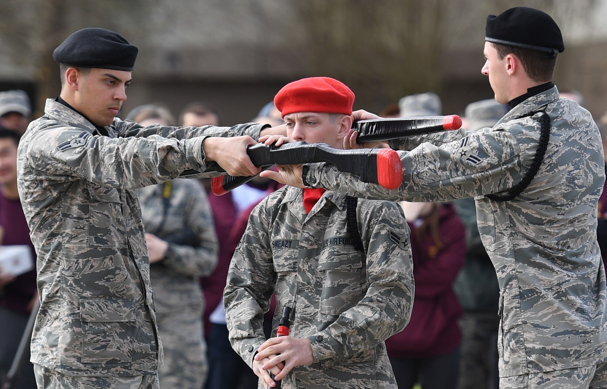 U.S. Air Force Airmen 1st Class Evan Berglund, Ryan Sweazy and Christopher Strnad, 336th Training Squadron freestyle drill team members, perform during the 81st Training Group drill down on the Levitow Training Support Facility drill pad at Keesler Air Force Base, Mississippi, March 8, 2019. Airmen from the 81st TRG competed in a quarterly open ranks inspection, regulation drill routine and freestyle drill routine. Keesler trains more than 30,000 students each year. While in training, Airmen are given the opportunity to volunteer to learn and execute drill down routines. (U.S. Air Force photo by Kemberly Groue)