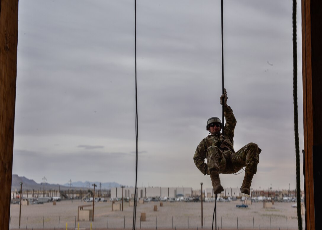 U.S. Senior Airman Kimball Butler, 377th Security Forces Group Air Assault trainee, rappels at Fort Bliss, Texas, March 8, 2019. The Fort Bliss Air Assault School is broken up into three different phases over 10 days that qualifies participants to conduct air mobile and air assault helicopter operations, which include aircraft orientation, sling load operations, rappelling techniques and fast-rope techniques. (U.S. Air Force photo by Airman 1st Class Austin J. Prisbrey)