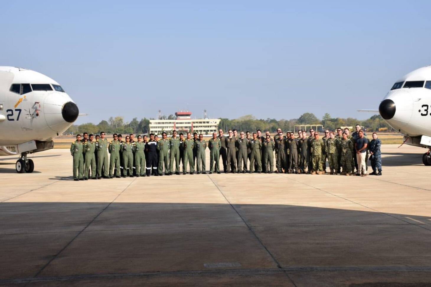 Arakkonam, INDIA (Feb. 28, 2019) Chief Electronics Technician (Submarine Communications) Robert Gulini, Electronics Technician 1st Class Raymond Acker, and Information Systems Technician 2nd Class Troy Haynes, assigned to Commander, Submarine Group 7, pose with bilateral aircrews during a subject matter expert exchange with the Indian Navy. Gulini, Acker and Haynes were selected to travel to India because of their extensive experience in information systems and communication networks.