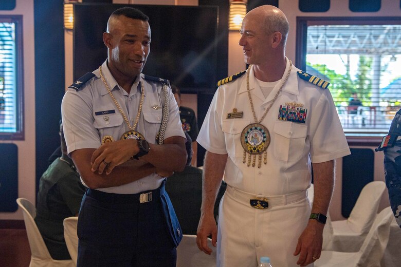 Capt. Randy Van Rossum, right, Pacific Partnership 2019 (PP19) mission commander, talks with Air Force Col. Larry Card II, U.S. Embassy in the Philippines Chief of Attaché Operations, during the PP19 Opening Ceremony. Pacific Partnership, now in its 14th iteration, is the largest annual multinational humanitarian assistance and disaster relief preparedness mission conducted in the Indo-Pacific. Each year the mission team works collectively with host and partner nations to enhance regional interoperability and disaster response capabilities, increase security and stability in the region, and foster new and enduring friendships in the Indo-Pacific.