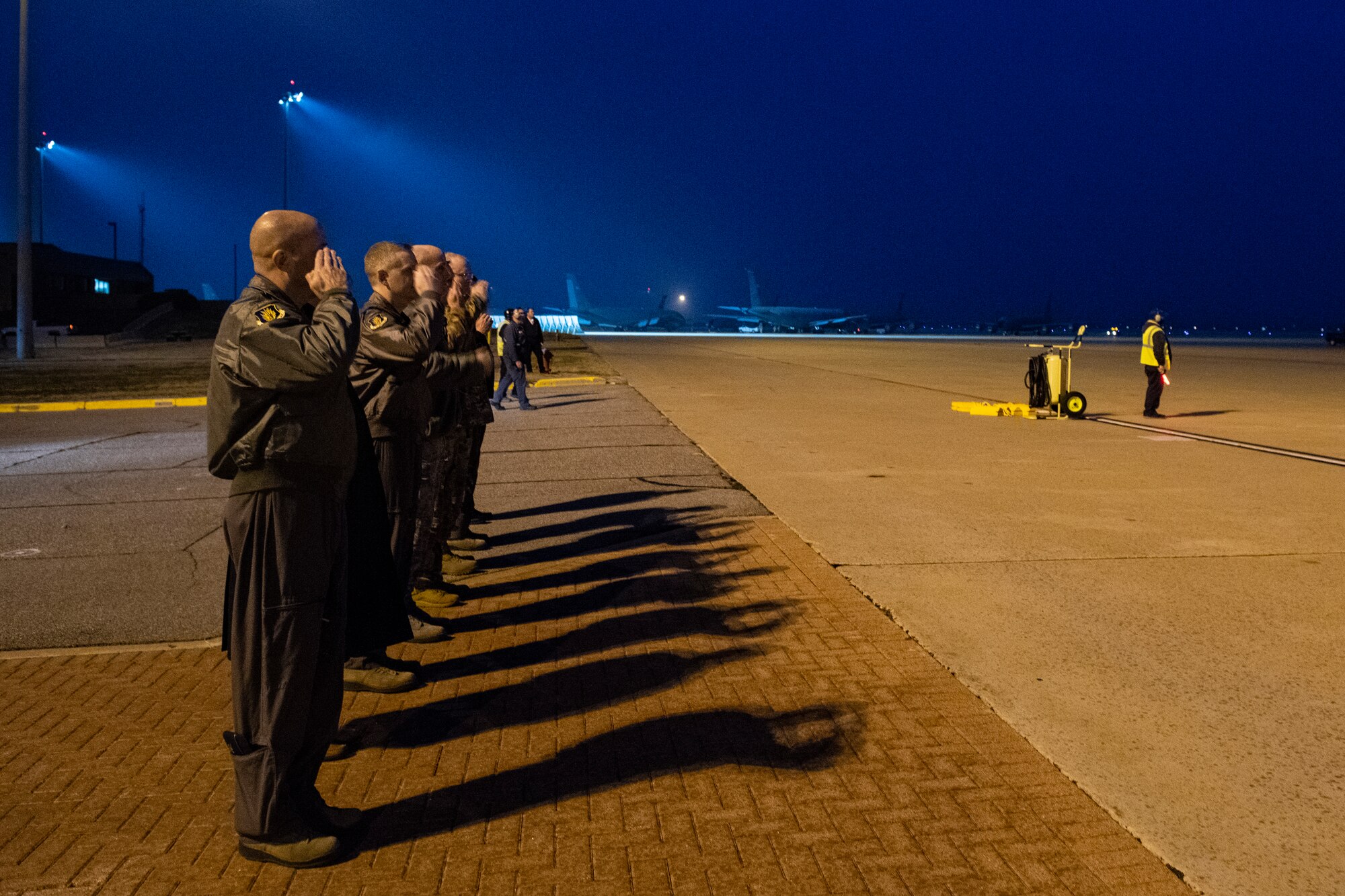 ALTUS AIR FORCE BASE, Okla. - U.S. Air Force Col. Eric Carney 97th Air Mobility Wing commander, and fellow members of Wing leadership, salute the arrival of a KC-46 Pegasus at Altus Air Force Base, Okla., March 11, 2019.