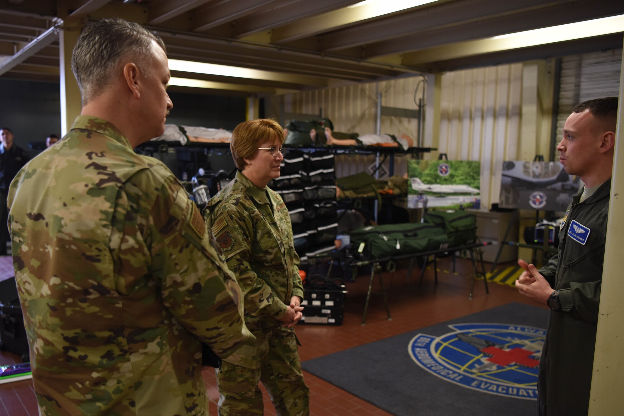 U.S. Air Force Staff Sgt. Tyler Reinhart, 86th Aeromedical Evacuation Squadron evacuation technician speaks with U.S. Air Force Lt. Gen. Dorothy Hogg, Air Force surgeon general and Chief Master Sgt. G. Steve Cum, chief medical enlisted force and enlisted corps chief, during a tour of the 86th AES facilities on Ramstein Air Base, Germany, March, 5, 2019. Reinhart explained the equipment, procedures and challenges of the 86th AES during a tour of their facilities.
