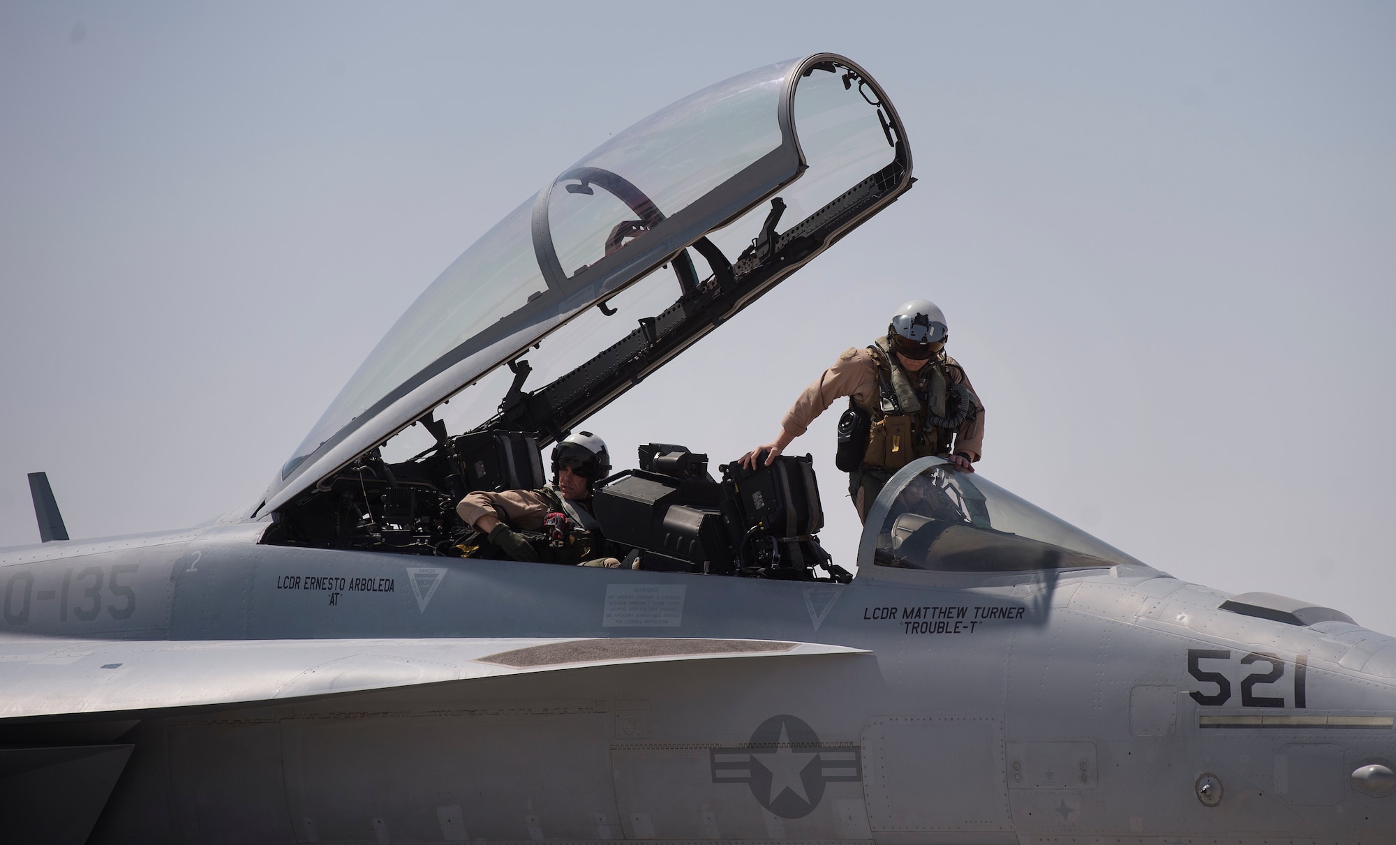 U.S. Navy EA-18G Growler pilots from the Electronic Attack Squadron 135 (VAQ-135) “Black Ravens,” get into an EA-18G Growler March 2, 2019, at Al Udeid Air Base, Qatar. VAQ-135 is deployed to the U.S. 5th Fleet area of operations in support of naval operations to ensure maritime stability and security in the Central Region, connecting the Mediterranean and the Pacific through the western Indian Ocean and three strategic choke points. The squadron’s EA-18G Growlers employ an electronic attack capability in support of combat missions across the region. (U.S. Air Force photo by Tech. Sgt. Christopher Hubenthal)