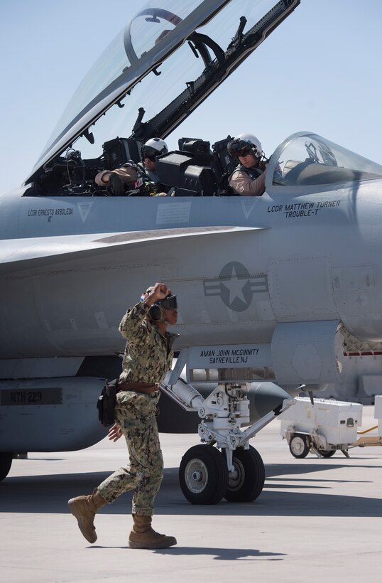 U.S. Navy Airman Shannon Barde, Electronic Attack Squadron 135 (VAQ-135) “Black Ravens” plane captain, uses hand signals to ensure pre-flight inspections for an EA-18G Growler are conducted safely March 2, 2019, at Al Udeid Air Base, Qatar. VAQ-135 is deployed to the U.S. 5th Fleet area of operations in support of naval operations to ensure maritime stability and security in the Central Region, connecting the Mediterranean and the Pacific through the western Indian Ocean and three strategic choke points. The squadron’s EA-18G Growlers employ an electronic attack capability in support of combat missions across the region. (U.S. Air Force photo by Tech. Sgt. Christopher Hubenthal)