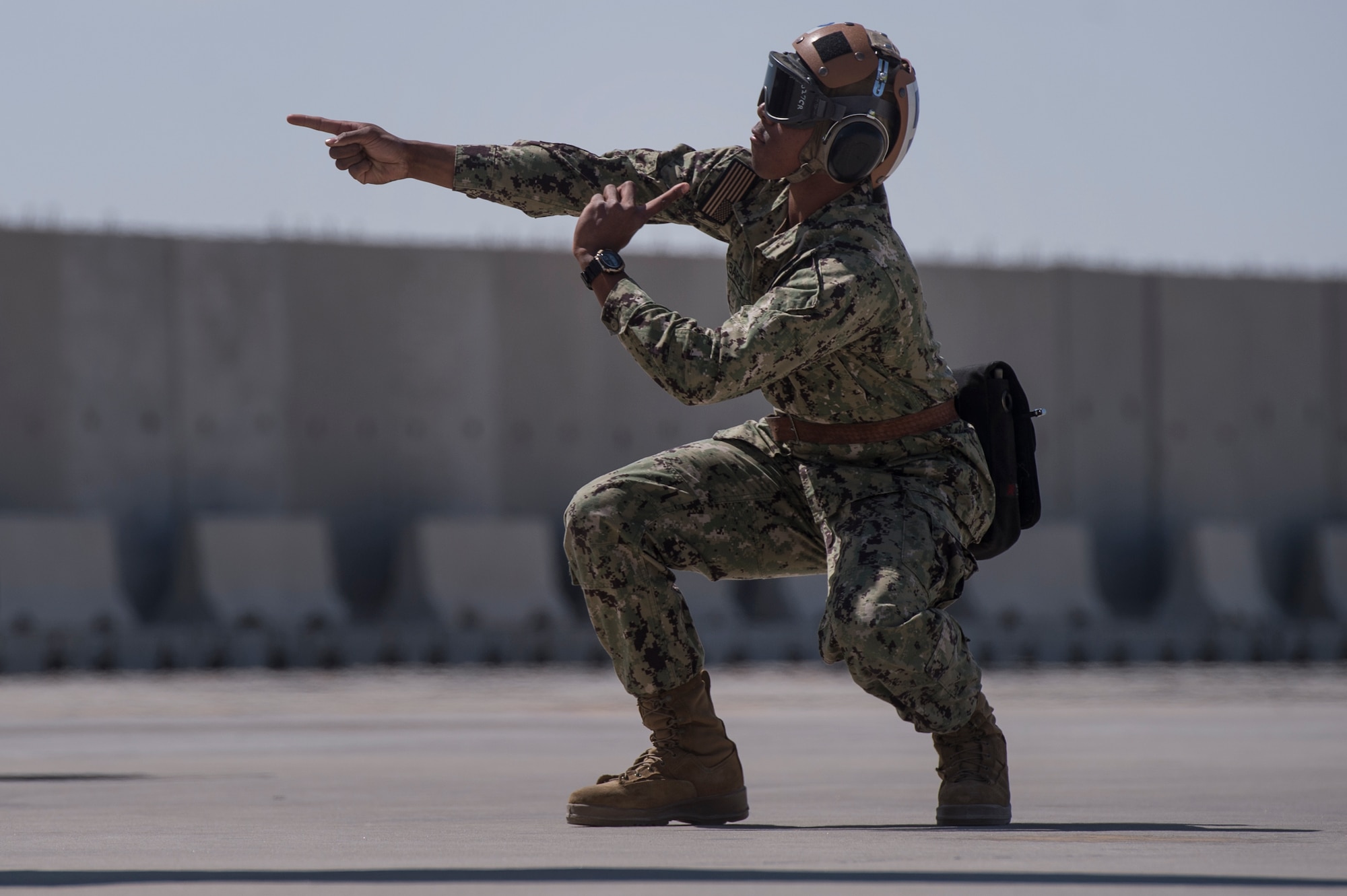 U.S. Navy Airman Shannon Barde, Electronic Attack Squadron 135 (VAQ-135) “Black Ravens” plane captain, uses hand signals to ensure pre-flight inspections for an EA-18G Growler are conducted safely March 2, 2019, at Al Udeid Air Base, Qatar. VAQ-135 is deployed to the U.S. 5th Fleet area of operations in support of naval operations to ensure maritime stability and security in the Central Region, connecting the Mediterranean and the Pacific through the western Indian Ocean and three strategic choke points. The squadron’s EA-18G Growlers employ an electronic attack capability in support of combat missions across the region. (U.S. Air Force photo by Tech. Sgt. Christopher Hubenthal)