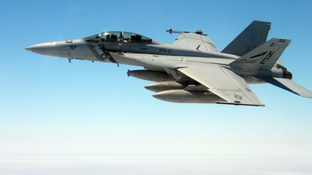 An F-18 Super Hornet is shown mid-flight