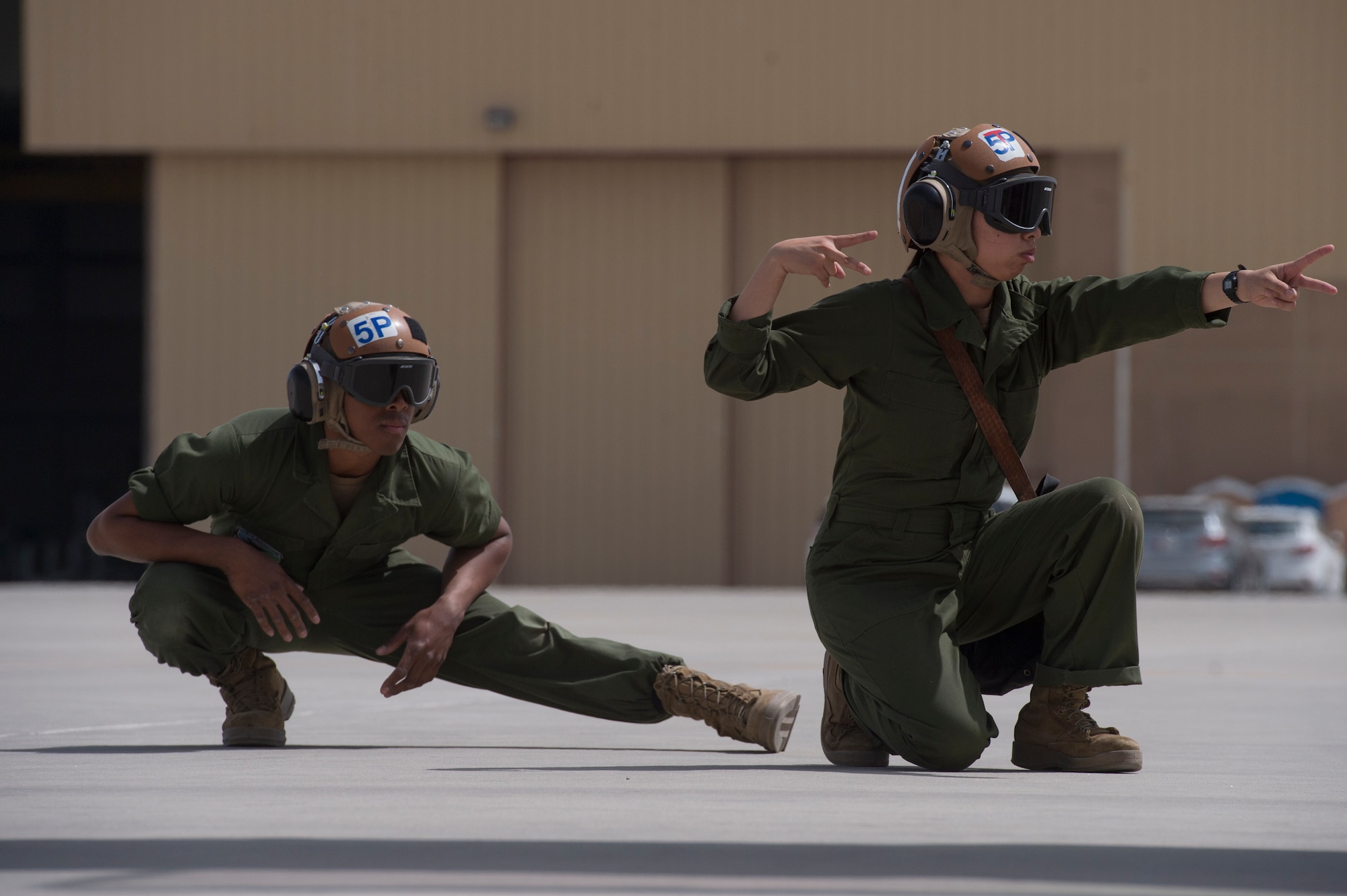 U.S. Navy Airman Shannon Barde, left, Electronic Attack Squadron 135 (VAQ-135) “Black Ravens” plane captain, and U.S. Navy Airman Waisum Cheung, VAQ-135, use hand signals to ensure pre-flight inspections for an EA-18G Growler are conducted safely March 4, 2019, at Al Udeid Air Base, Qatar. VAQ-135 is deployed to the U.S. 5th Fleet area of operations in support of naval operations to ensure maritime stability and security in the Central Region, connecting the Mediterranean and the Pacific through the western Indian Ocean and three strategic choke points. The squadron’s EA-18G Growlers employ an electronic attack capability in support of combat missions across the region. (U.S. Air Force photo by Tech. Sgt. Christopher Hubenthal)