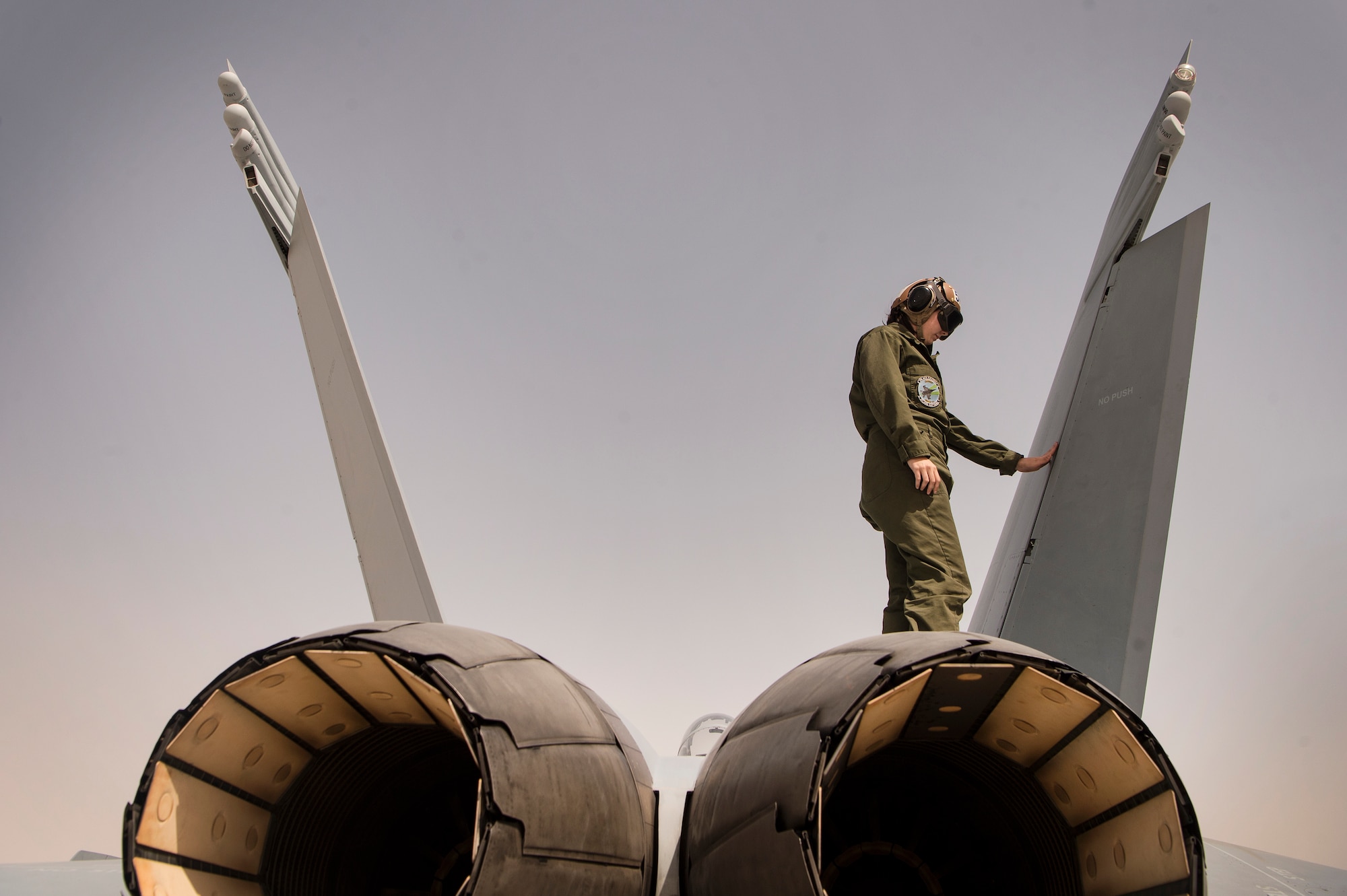 U.S. Navy Airman Madison Arthur, Electronic Attack Squadron 135 (VAQ-135) “Black Ravens” aviation structural mechanic, examines an EA-18G Growler as part of a pre-launch inspection March 7, 2019, at Al Udeid Air Base, Qatar. VAQ-135 is deployed to the U.S. 5th Fleet area of operations in support of naval operations to ensure maritime stability and security in the Central Region, connecting the Mediterranean and the Pacific through the western Indian Ocean and three strategic choke points. Through the use of EA-18G Growler aircraft, VAQ-135 brings electronic based airborne attack and defense capabilities to Al Udeid’s joint environment by detecting, identifying, locating, and suppressing hostile “emitters.” (U.S. Air Force photo by Tech. Sgt. Christopher Hubenthal)