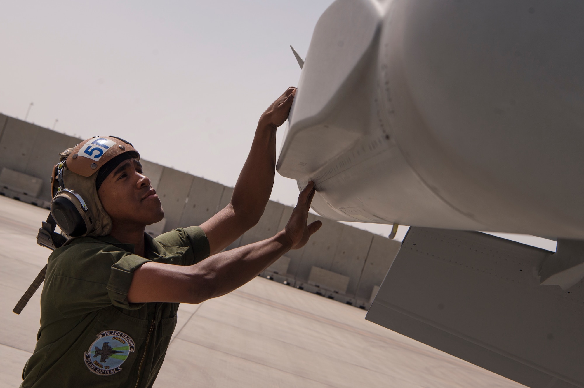 U.S. Navy Airman Shannon Barde, Electronic Attack Squadron 135 (VAQ-135) “Black Ravens” plane captain, conducts a pre-flight inspection for an EA-18G Growler are conducted safely March 7, 2019, at Al Udeid Air Base, Qatar. VAQ-135 is deployed to the U.S. 5th Fleet area of operations in support of naval operations to ensure maritime stability and security in the Central Region, connecting the Mediterranean and the Pacific through the western Indian Ocean and three strategic choke points. Through the use of EA-18G Growler aircraft, VAQ-135 brings electronic based airborne attack and defense capabilities to Al Udeid’s joint environment by detecting, identifying, locating, and suppressing hostile “emitters.” (U.S. Air Force photo by Tech. Sgt. Christopher Hubenthal)
