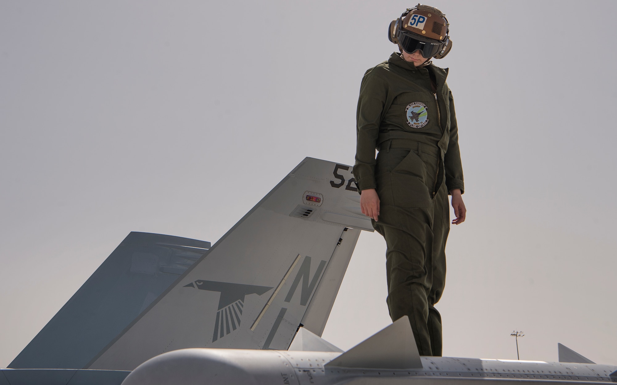 U.S. Navy Airman Madison Arthur, Electronic Attack Squadron 135 (VAQ-135) “Black Ravens” aviation structural mechanic, examines the wing of an EA-18G Growler as part of a pre-launch inspection March 7, 2019, at Al Udeid Air Base, Qatar. VAQ-135 is deployed to the U.S. 5th Fleet area of operations in support of naval operations to ensure maritime stability and security in the Central Region, connecting the Mediterranean and the Pacific through the western Indian Ocean and three strategic choke points. Through the use of EA-18G Growler aircraft, VAQ-135 brings electronic based airborne attack and defense capabilities to Al Udeid’s joint environment by detecting, identifying, locating, and suppressing hostile “emitters.” (U.S. Air Force photo by Tech. Sgt. Christopher Hubenthal)
