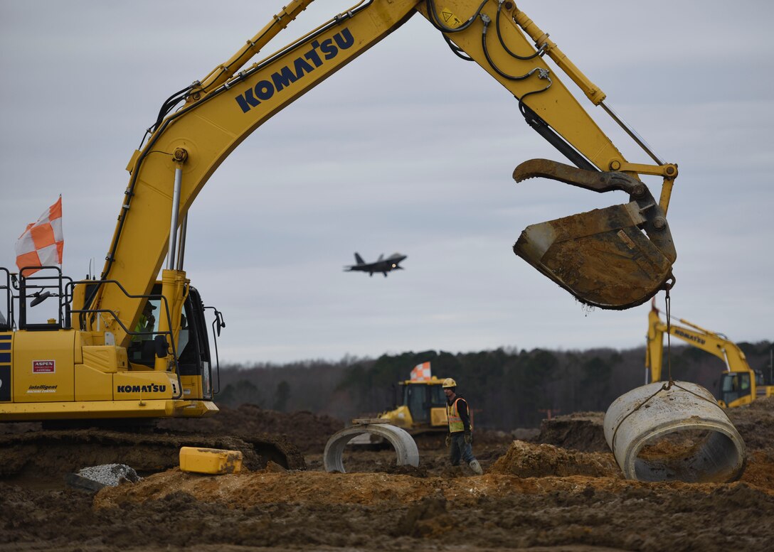 Aspen Construction workers move a segment of cement pipe on the airfield construction site at Joint Base Langley-Eustis, Virginia, March 4, 2019.