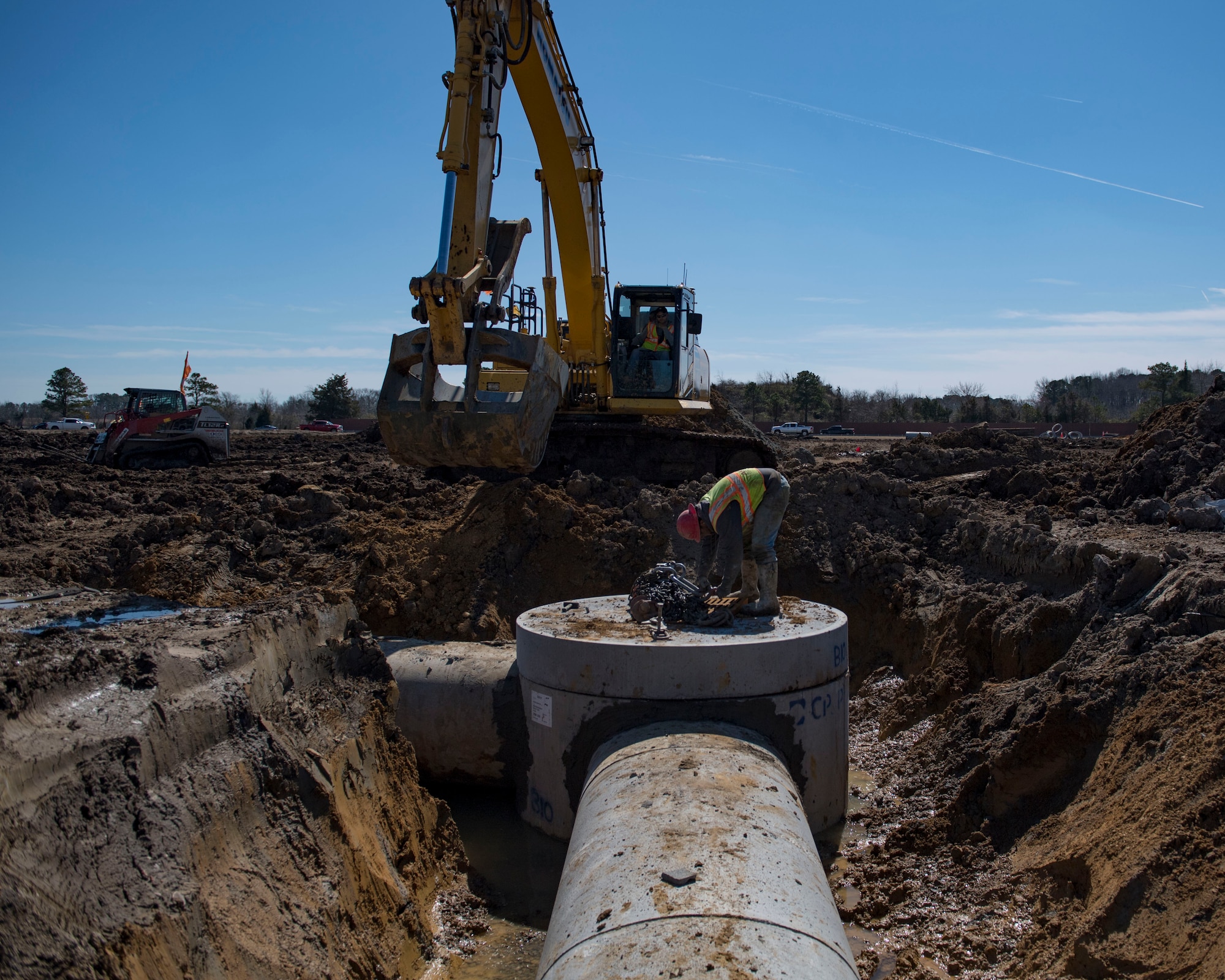 An Aspen Construction worker secures chains at Joint Base Langley-Eustis, Virginia, March 7, 2019.