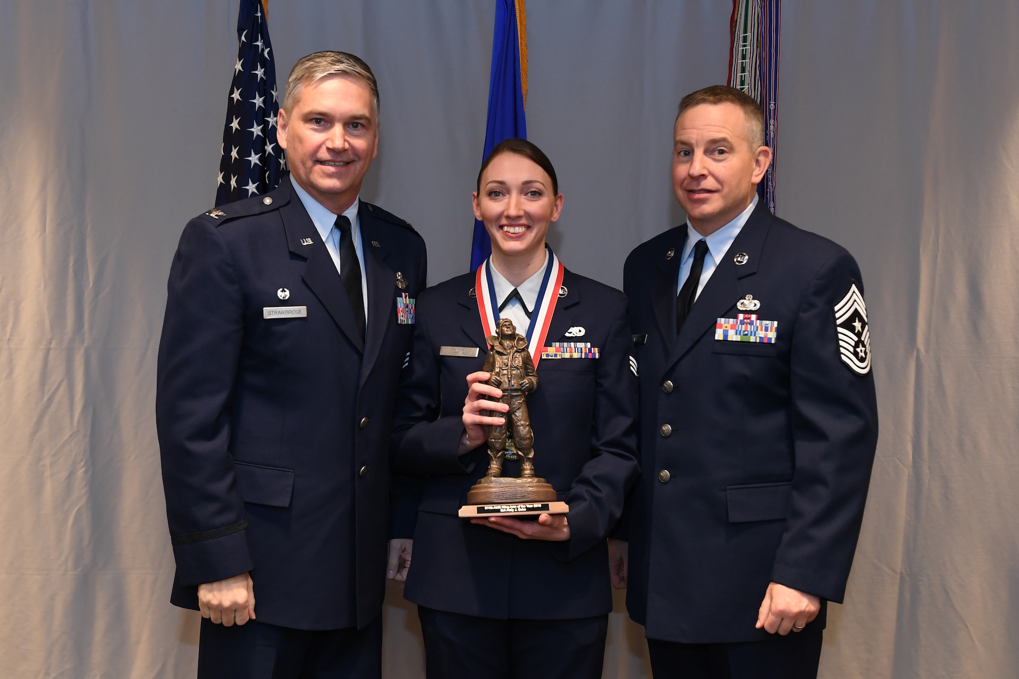 Senior Airman Brianna Humbert, aerospace maintenance with the 911th Maintenance Squadron, is awarded the Command Chief Fahrny Diamond Sharp Award by Col. Douglas N. Strawbridge, commander of the 911th Airlift Wing, and Chief Master Sgt. Christopher D. Neitzel, command chief of the 911th AW, during the 911th AW Annual Award Ceremony at the Pittsburgh International Airport Air Reserve Station, Pennsylvania, March 2, 2019. The 2018 awards ceremony recognized Airmen who went above and beyond in their service for the year 2018. (U.S. Air Force photo by Senior Airman Grace Thomson)