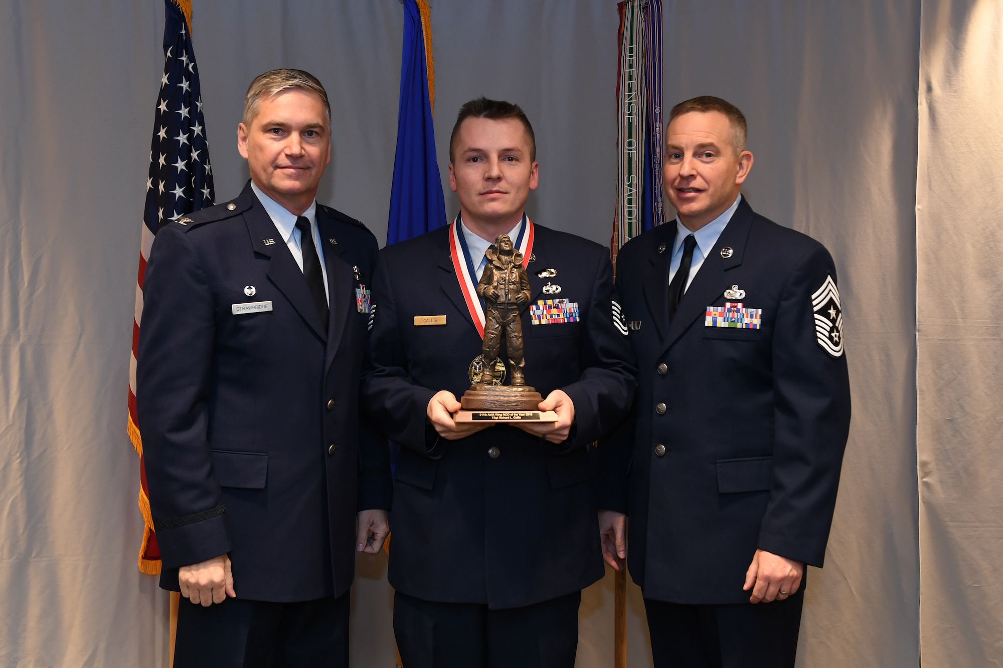 Master Sgt. Tech. Sgt. Richard Callis, unit training manager with the 911th Logistics Readiness Squadron, is awarded 911th Airlift Wing Noncommissioned Officer of the Year by Col. Douglas N. Strawbridge, commander of the 911th AW, and Chief Master Sgt. Christopher D. Neitzel, command chief of the 911th AW, during the 911th AW Annual Award Ceremony at the Pittsburgh International Airport Air Reserve Station, Pennsylvania, March 2, 2019. The 2018 awards ceremony recognized Airmen who went above and beyond in their service for the year 2018. (U.S. Air Force photo by Senior Airman Grace Thomson)