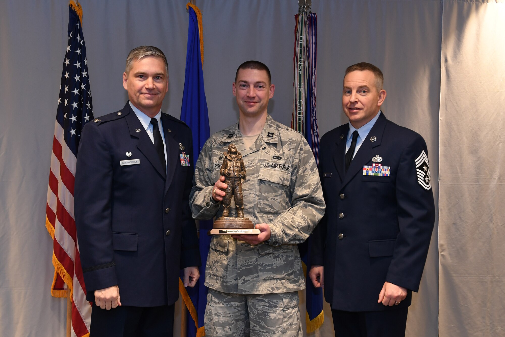 Captain Joshua Christopher, operations officer with the 911th Maintenance Squadron, is awarded 911th Airlift Wing Company Grade Officer of the Year by Col. Douglas N. Strawbridge, commander of the 911th AW, and Chief Master Sgt. Christopher D. Neitzel, command chief of the 911th AW, during the 911th AW Annual Award Ceremony at the Pittsburgh International Airport Air Reserve Station, Pennsylvania, March 2, 2019. The 2018 awards ceremony recognized Airmen who went above and beyond in their service for the year 2018. (U.S. Air Force photo by Senior Airman Grace Thomson)