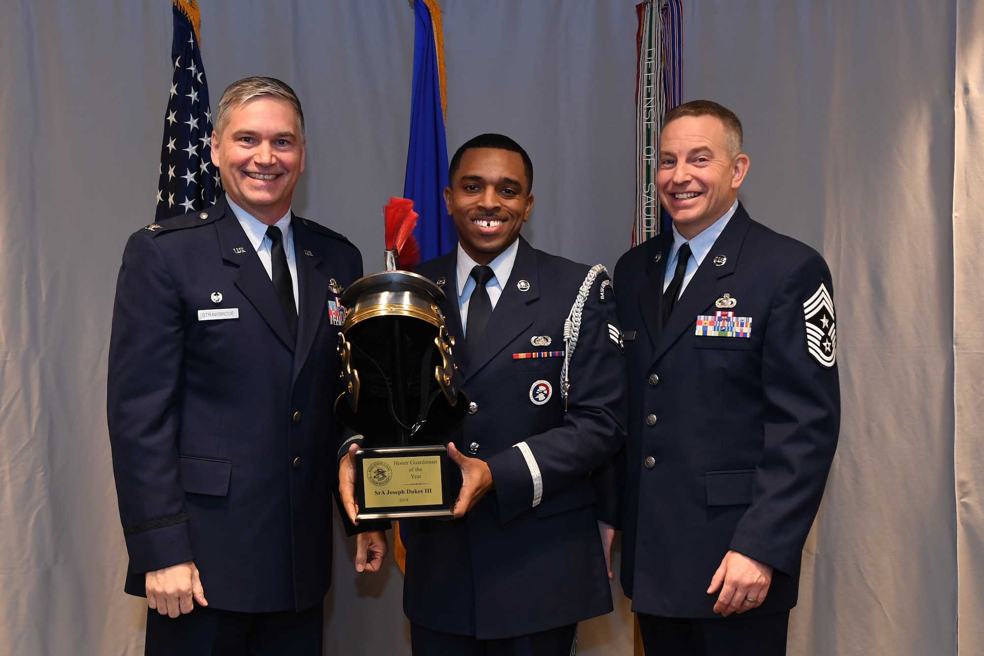 Senior Airman Joseph Dukes, knowledge operations management with the 911th Communications Squadron, is awarded 911th Airlift Wing Base Honor Guardsman of the Year by Col. Douglas N. Strawbridge, commander of the 911th AW, and Chief Master Sgt. Christopher D. Neitzel, command chief of the 911th AW, during the 911th AW Annual Award Ceremony at the Pittsburgh International Airport Air Reserve Station, Pennsylvania, March 2, 2019. The 2018 awards ceremony recognized Airmen who went above and beyond in their service for the year 2018. (U.S. Air Force photo by Senior Airman Grace Thomson)