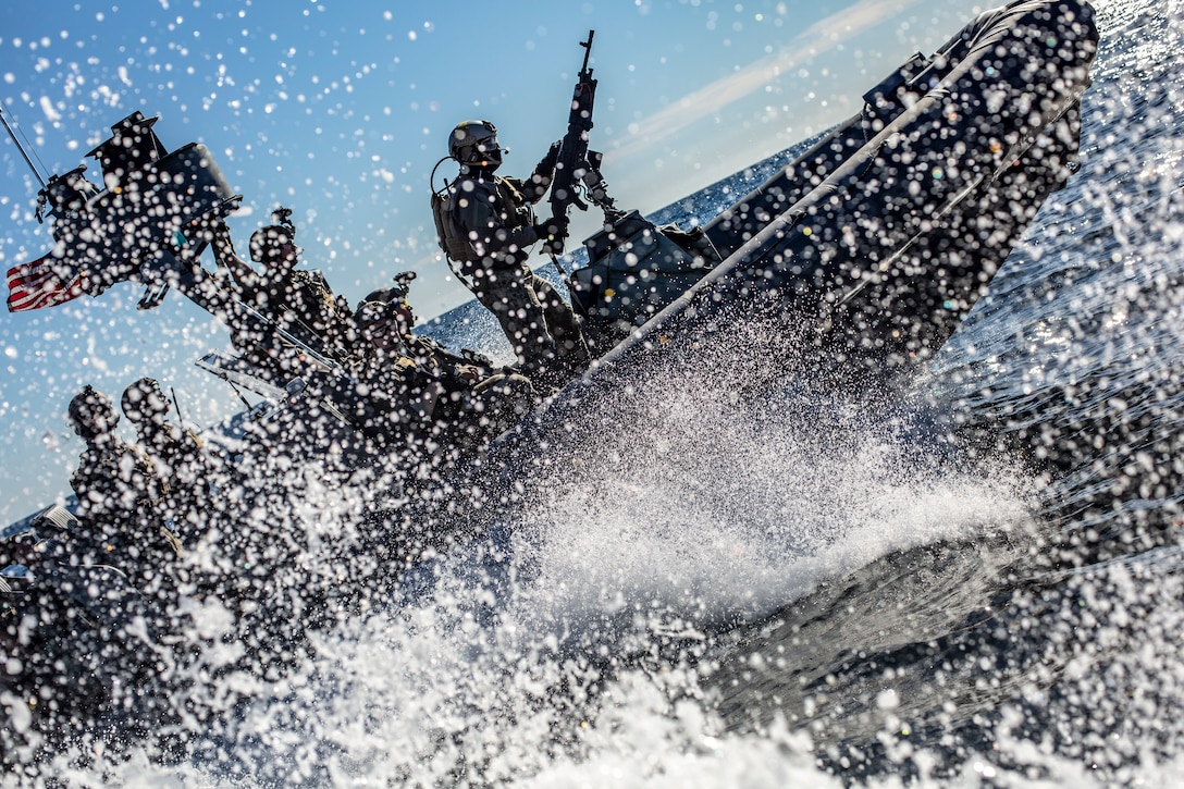 U.S. Marines and Sailors with the Maritime Raid Force, 11th Marine Expeditionary Unit, ride in a rigid-hull inflatable boat during a visit, board, search and seizure exercise. The Marines and Sailors of the 11th MEU are conducting routine operations as part of the Boxer Amphibious Ready Group in the eastern Pacific Ocean.