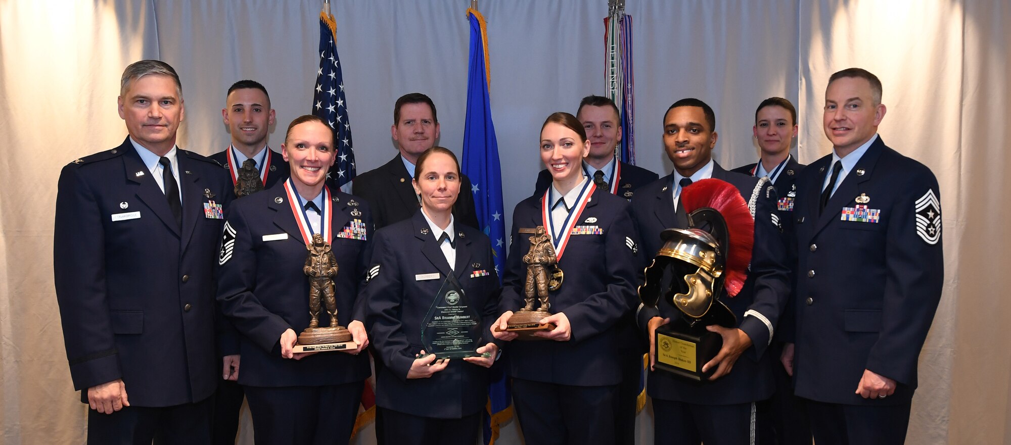 911th Airlift Wing award winners stand to be recognized with Col. Douglas N. Strawbridge, commander of the 911th AW, and Chief Master Sgt. Christopher D. Neitzel, command chief of the 911th AW, during the 911th AW Annual Award Ceremony at the Pittsburgh International Airport Air Reserve Station Pennsylvania, March 2, 2019. The 2018 Awards Ceremony recognizes Airmen that went above and beyond in their service for the year 2018. (U.S. Air Force Photo by Senior Airman Grace Thomson)
